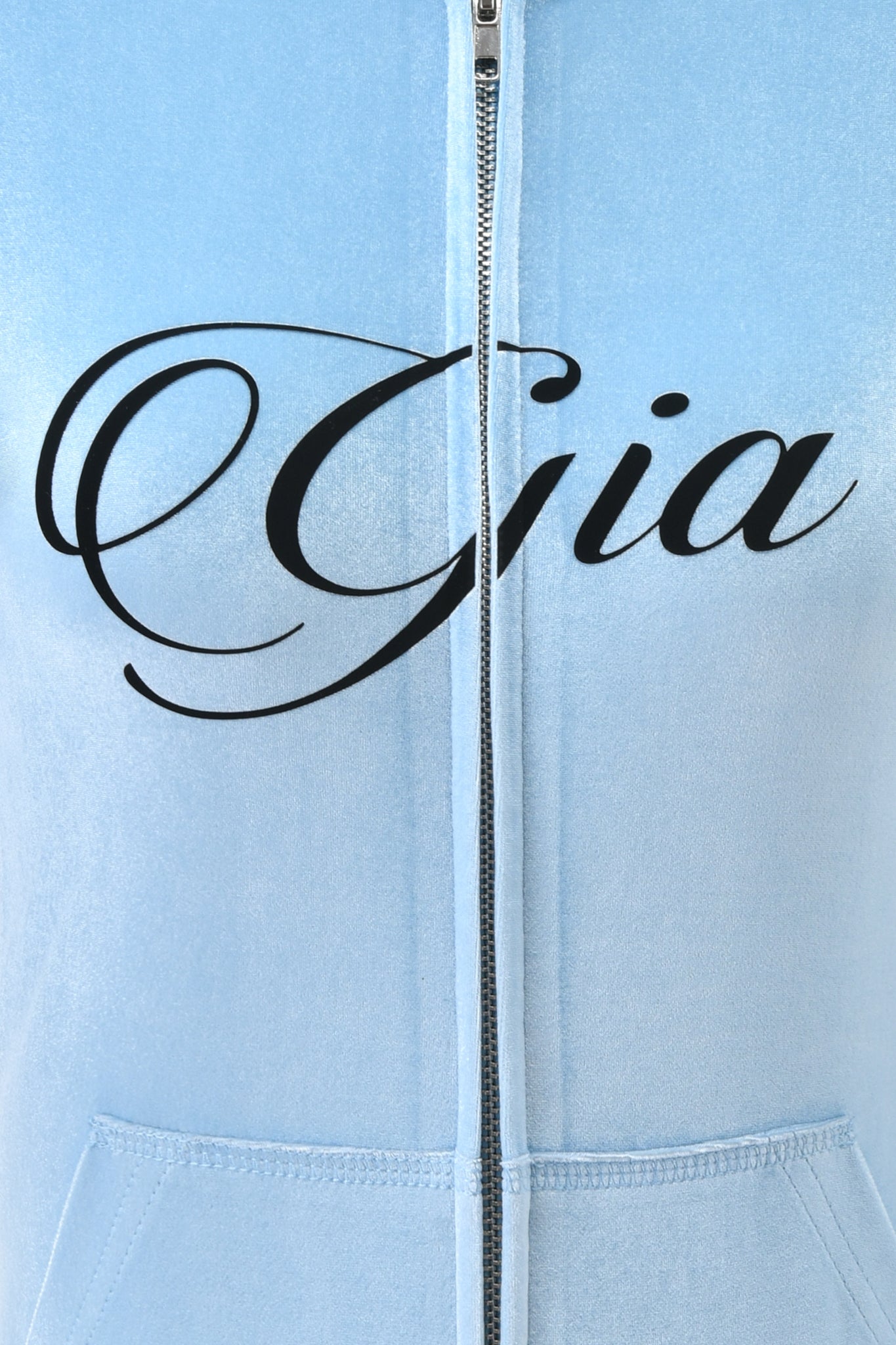 Close-up of the I.AM.GIA BLARE VELOUR POCKET HOODIE in ice blue, featuring "Gia" in bold black script across the chest.
