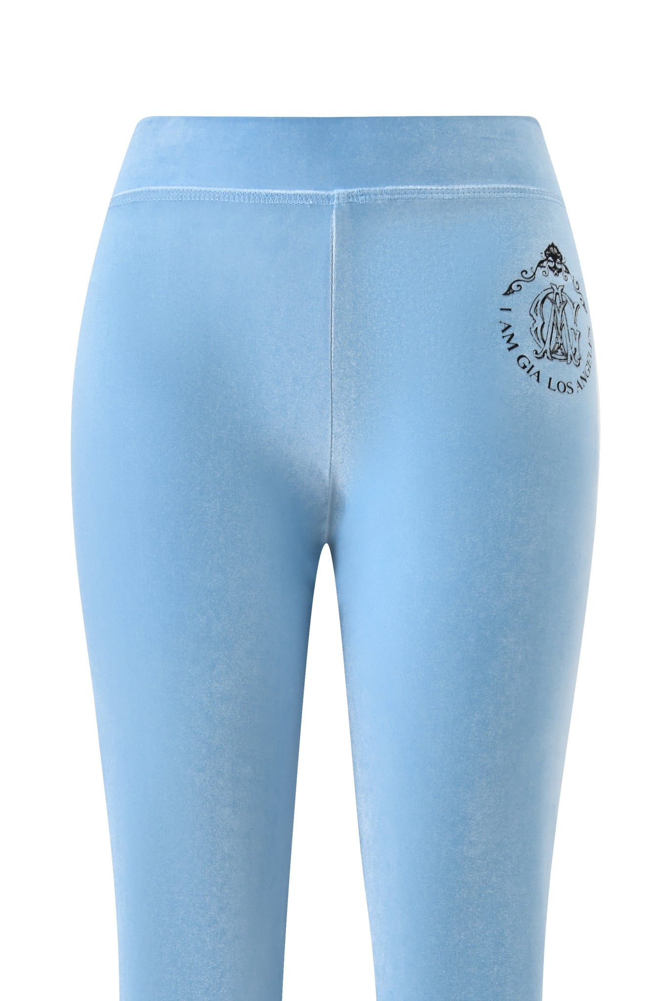 The BLARE VELOUR POCKET TRACKPANT in ice blue by I.AM.GIA features a flattering mid-rise waist and a small black GIA script logo on the upper left near the waistband, shown from the back.