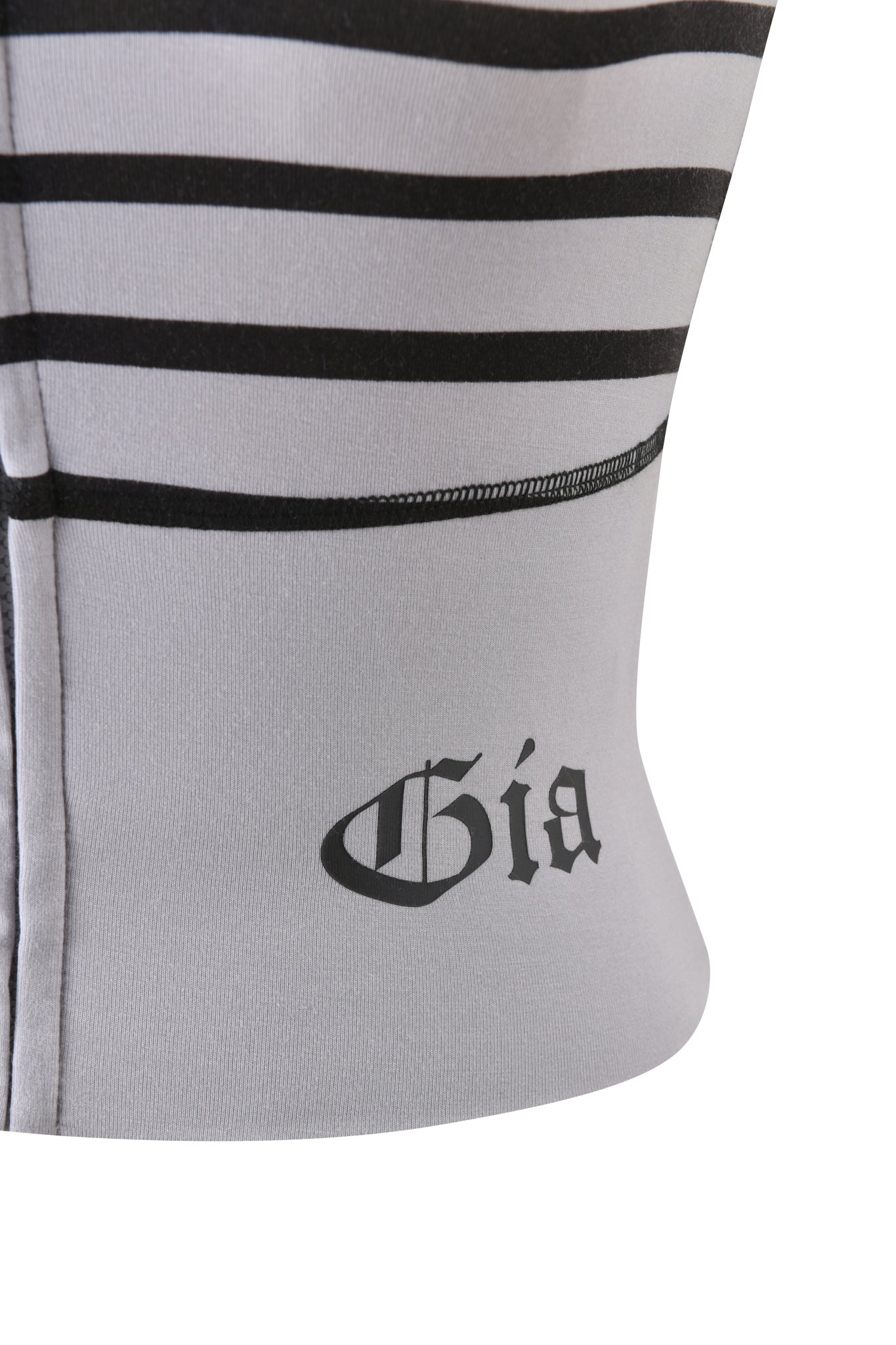 Close-up of the buttery-soft BLARE ZIP BOOB TUBE by I.AM.GIA, featuring grey and black stripes with "Gía" in a black gothic font near the seam—ideal for fans of sleek, bold styles.