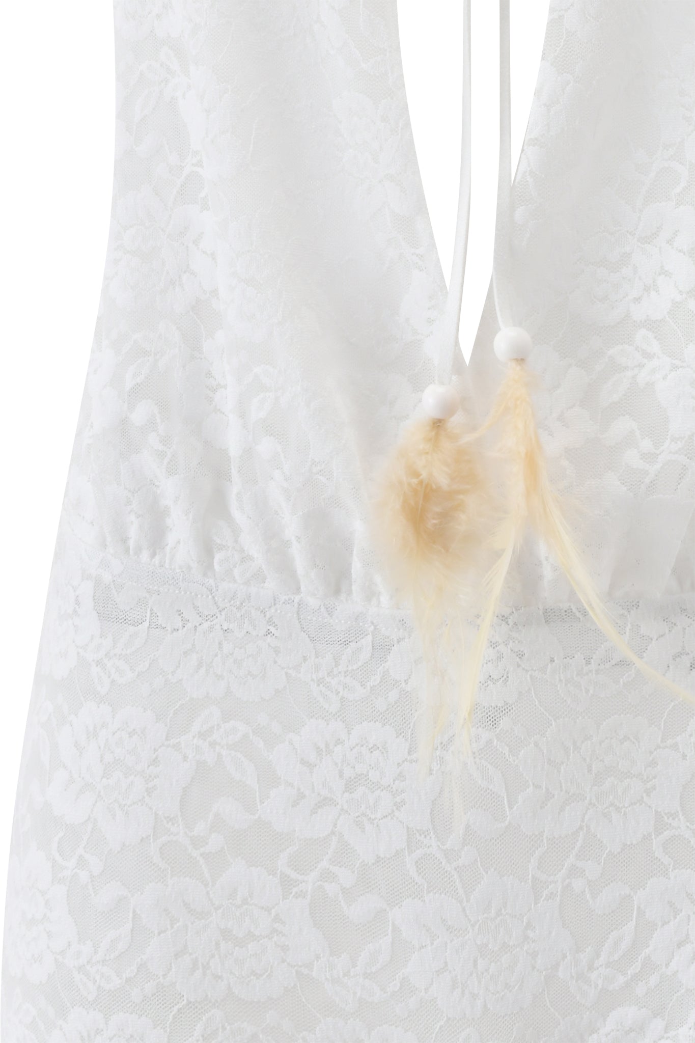 Close-up of the PHERN PLAYSUIT - WHITE by I.AM.GIA, showcasing its delicate white floral lace, a back drawstring tie, and beige feather accents at the ends.
