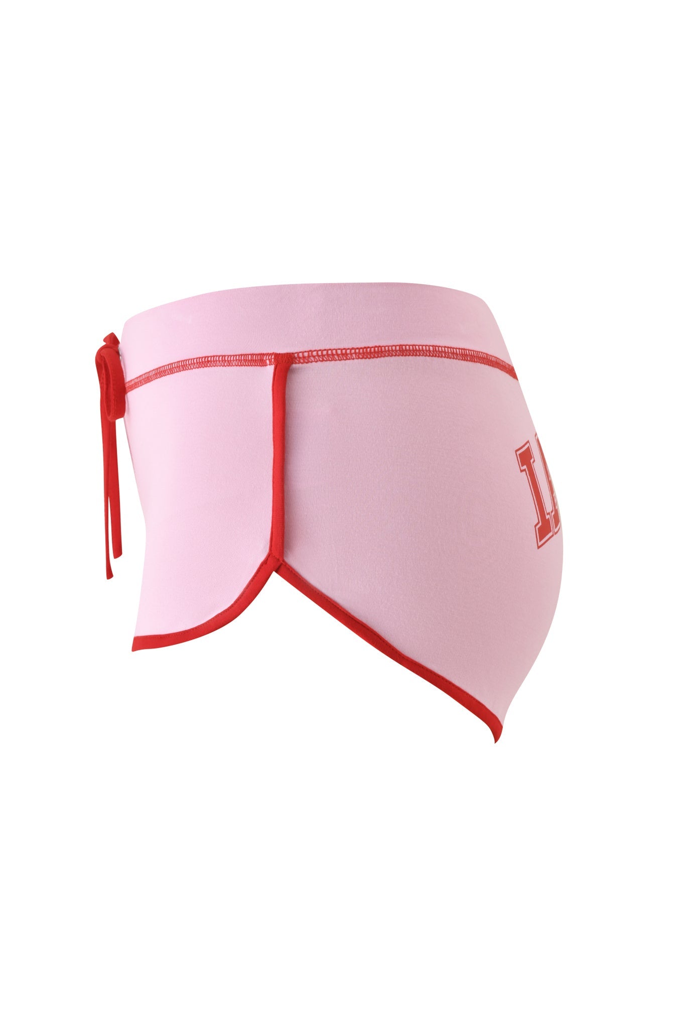 Side view of the I.AM.GIA BLARE DOLPHIN SHORT in baby pink, featuring red trim and a back tie, with a red letter "L" printed on the right side—perfect for pairing with bamboo mini skirts or other summer beachwear.