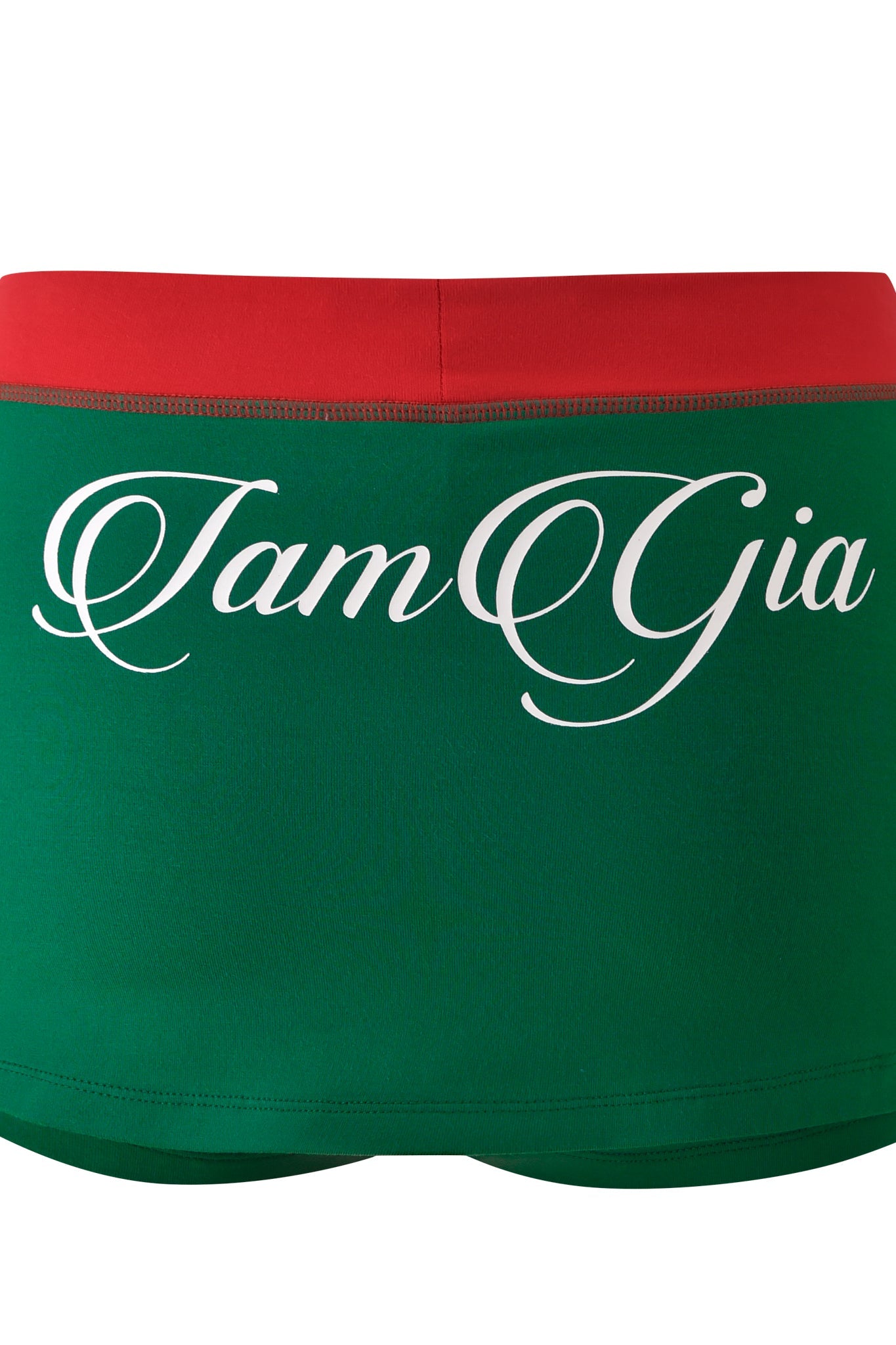 The BLARE VARSITY MICRO SKORT - GREEN by I.AM.GIA features a red waistband, buttery-soft fabric, and bold white cursive "I.AM.GIA" lettering across the back.