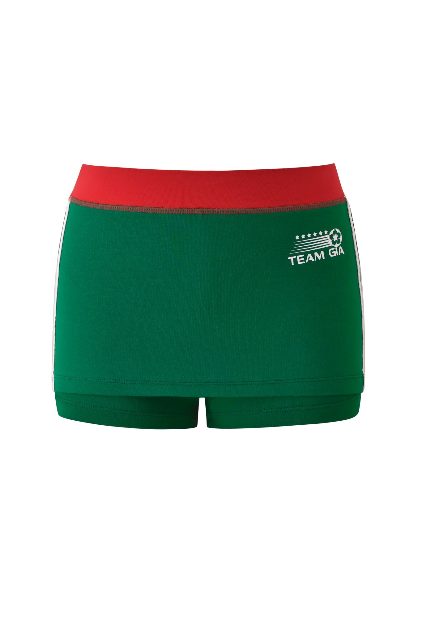 The BLARE VARSITY MICRO SKORT - GREEN by I.AM.GIA features a red waistband, white side stripes, buttery-soft fabric, and a “TEAM GIA” logo with soccer ball graphic on the left hip for sporty style.