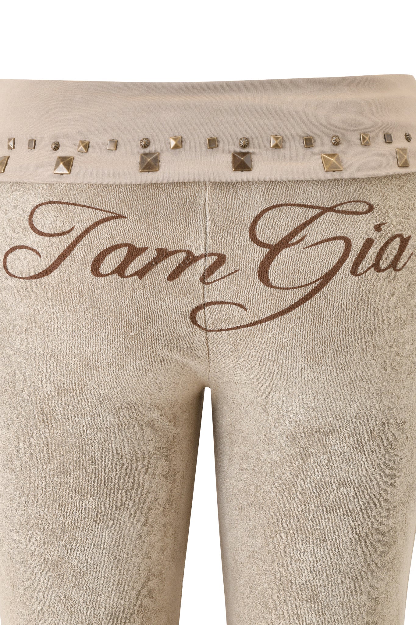Close-up of I.AM.GIA's BLARE STUDDED TERRY PANT in Stone, featuring “I am Gia” script on the front and a waistband adorned with metallic square and round studs.