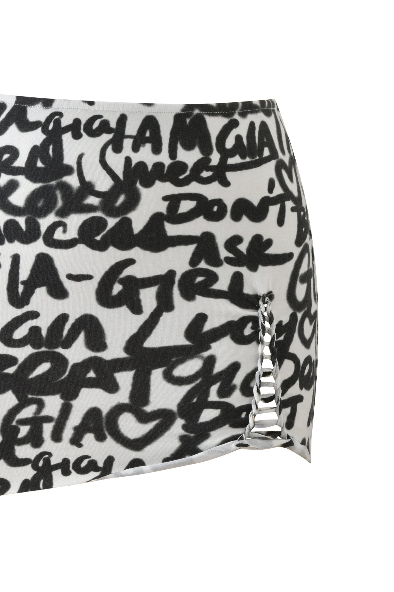 The I.AM.GIA HONEY MACRAME MINI SKIRT - WRITING ON THE WALL features bold black graffiti text and heart prints on white, plus a side cut-out with silver rings for an edgy bodycon look that makes a statement.