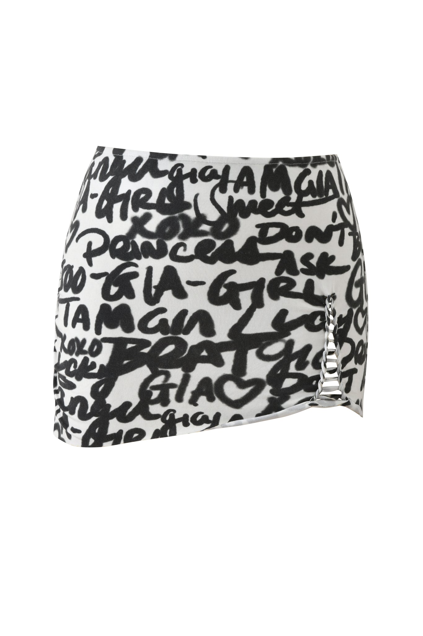 The I.AM.GIA HONEY MACRAME MINI SKIRT - WRITING ON THE WALL features black and white graffiti-style text, an asymmetrical hem, and a silver chain on the right side, creating an edgy look against a crisp white background.