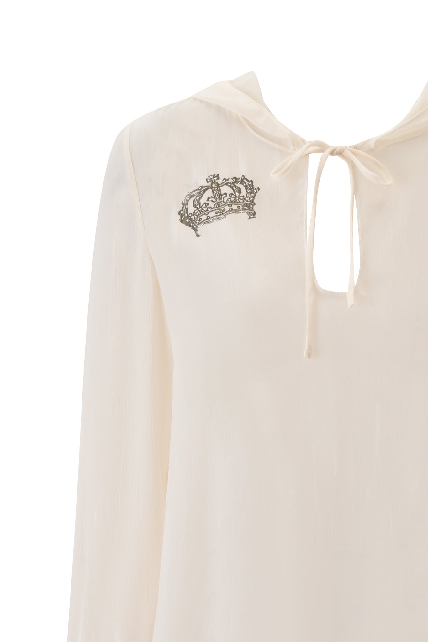 The DIAMOND 2-IN-1 MINI DRESS in cream by I.AM.GIA features a light, elegant look with a long-sleeve design, keyhole neckline with ribbon tie, and a small black crown graphic on the chest. Background is white.