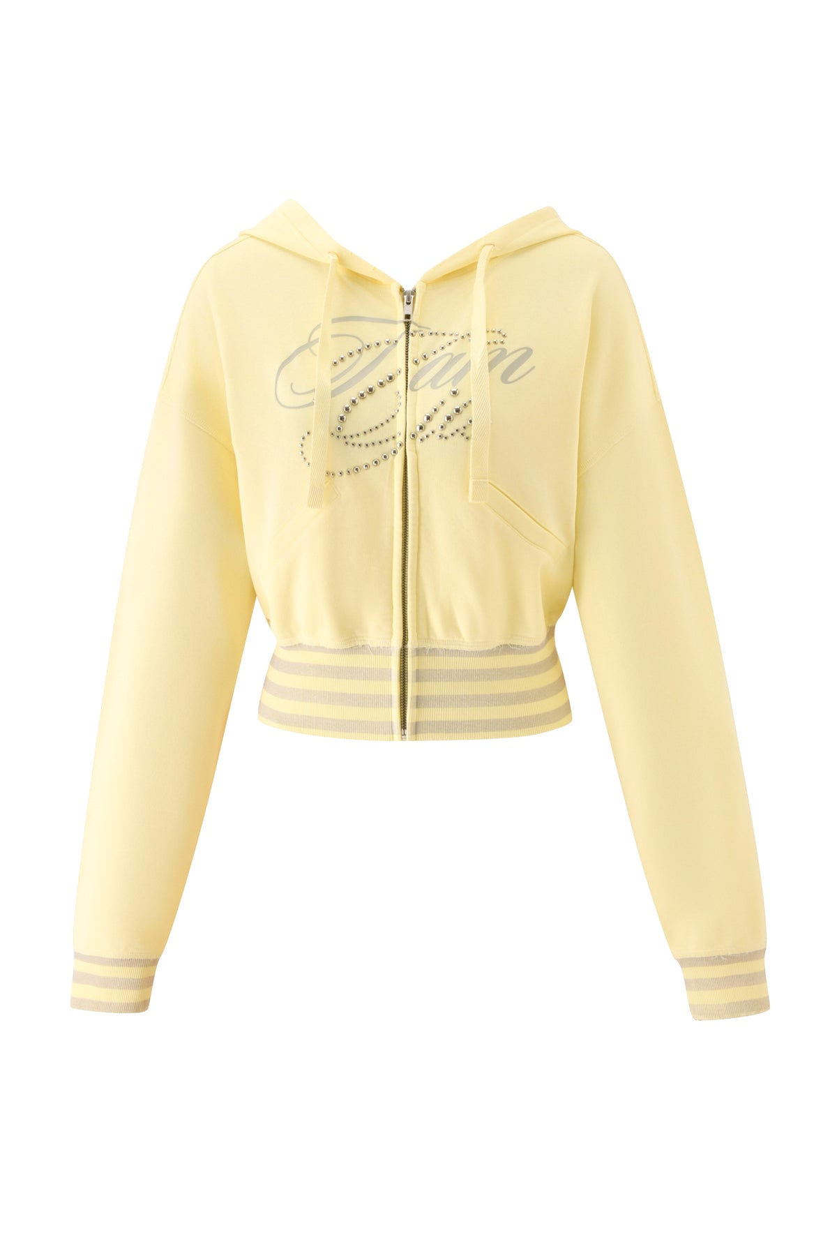 The VEDA JACKET - YELLOW by I.AM.GIA is a pale yellow zip-up hoodie featuring a front zipper, drawstring hood, ribbed cuffs and hem with white stripes, and oversized decorative GIA script rhinestone text with sparkling embellishments on the chest.