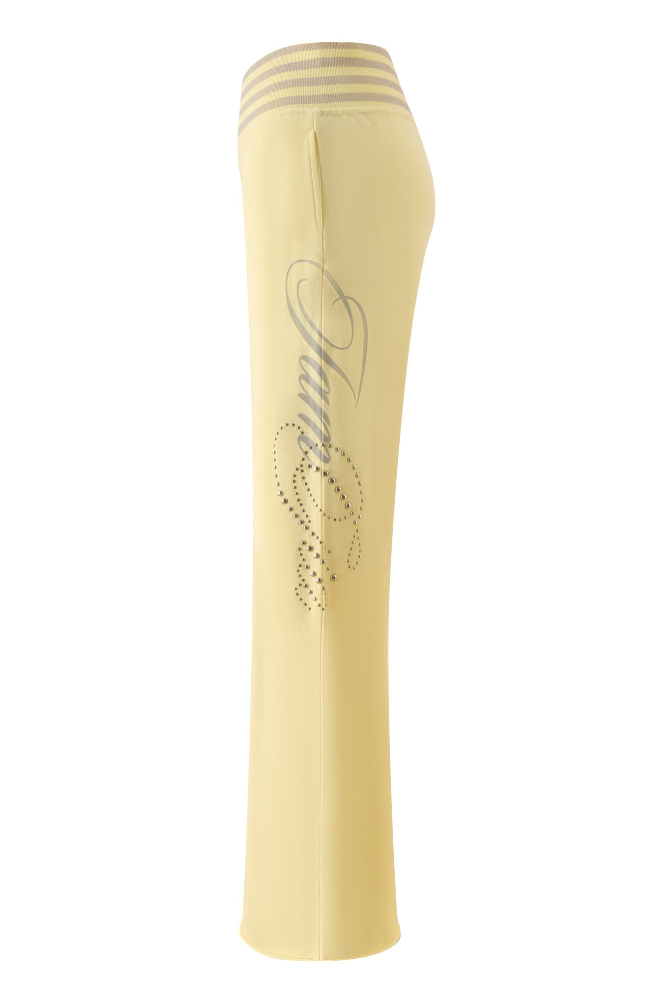 The VEDA PANT - YELLOW by I.AM.GIA features a trendy wide-leg silhouette with a wide waistband, silver stripes at the top, rhinestone embellishments, and cursive script detailing along the side.
