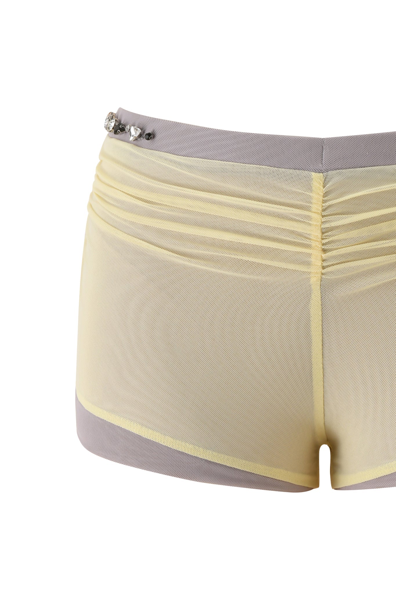 The AMATHA SHORT - BUTTER YELLOW by I.AM.GIA features a sheer, butter yellow mesh body, low-rise waist, grey trim, and stylish rhinestone accents on the left waistband for a chic micro mini look.