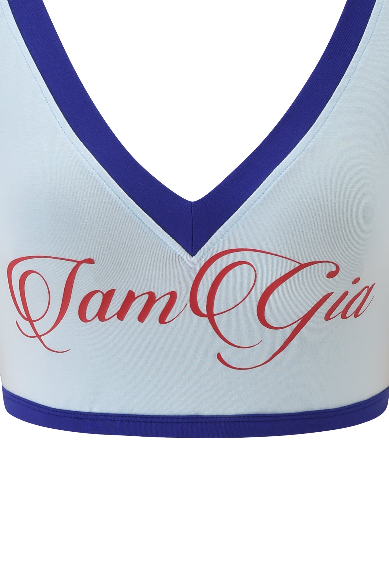 Close-up of the I.AM.GIA BLARE SPORT CROP TEE AND HEADBAND in baby blue with dark blue trim, featuring bold red "I am Gia" script on the front for a signature crop top style.