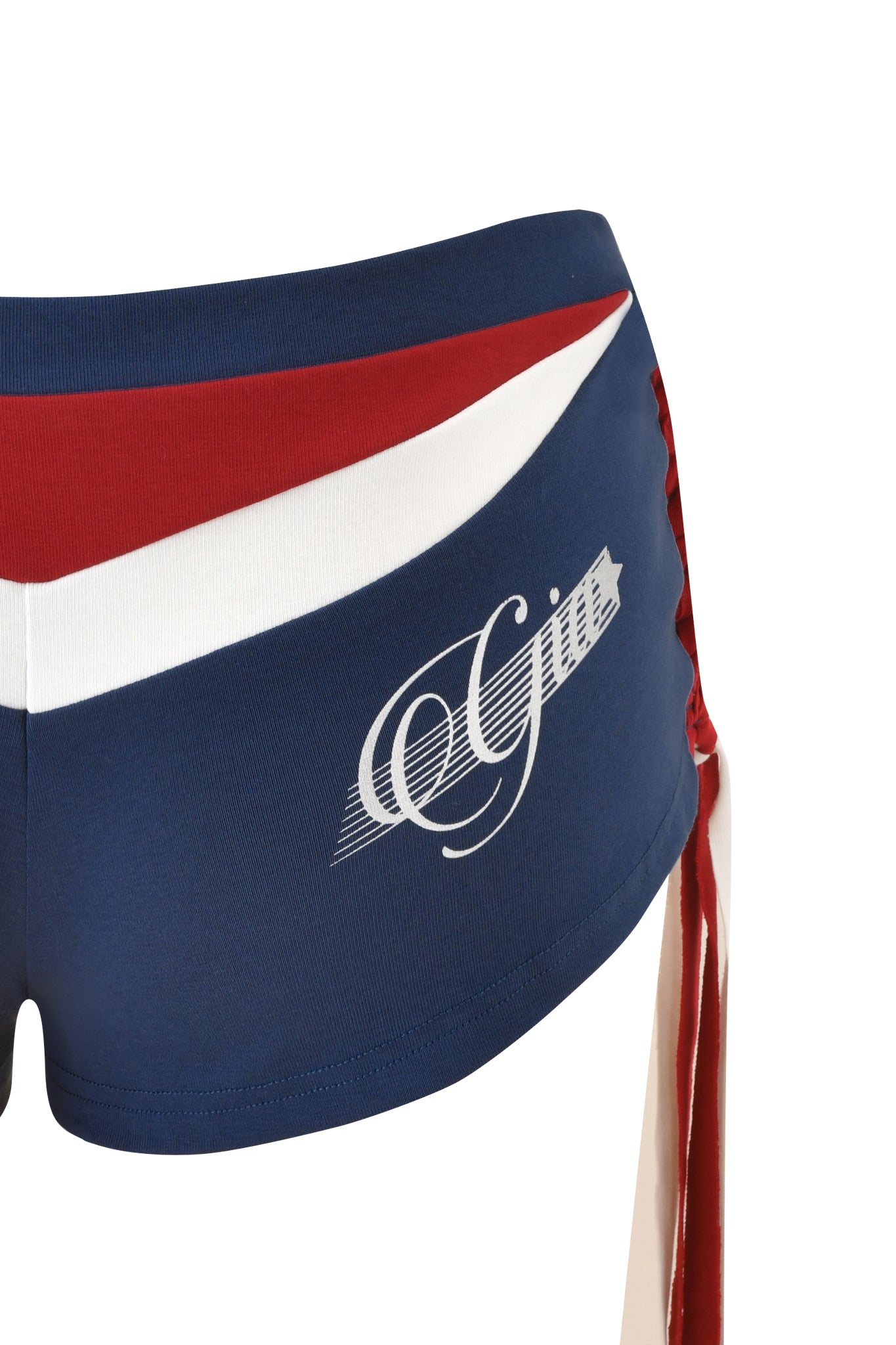 Close-up of the I.AM.GIA NOVIA MICRO SPORT SHORT - NAVY: sporty, low-rise stretch cotton shorts featuring red and white diagonal stripes, "Gym" script on the side, and red and white laces along the right seam.