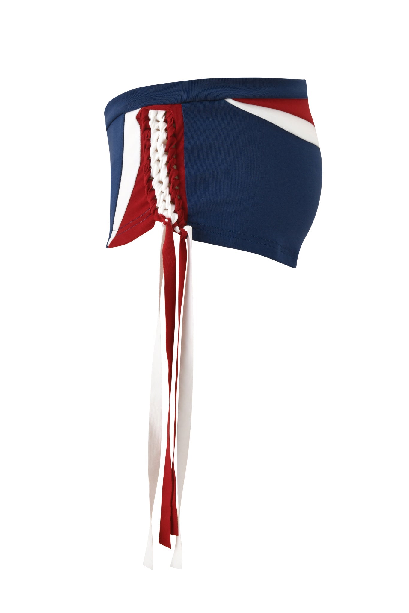 The I.AM.GIA NOVIA MICRO SPORT SHORT - NAVY is a high-waisted stretch cotton soccer short in navy with side lace-up detail and long red and white ribbon ties, shown against a white background.