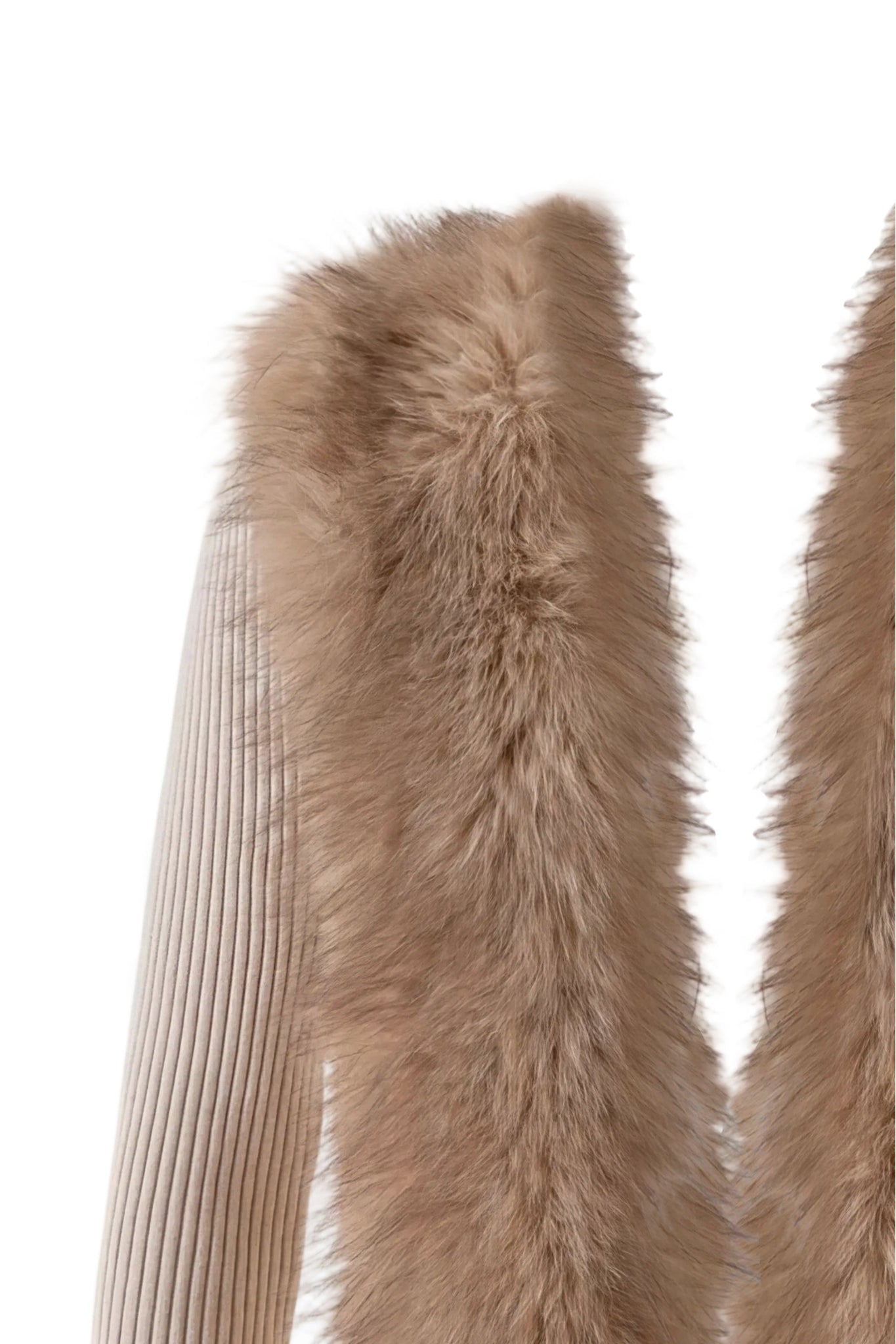 Close-up of the KYTIA FAUX FUR CARDIGAN in beige by I.AM.GIA, showcasing a ribbed sleeve and a soft, light brown faux fur panel, set against a white background.