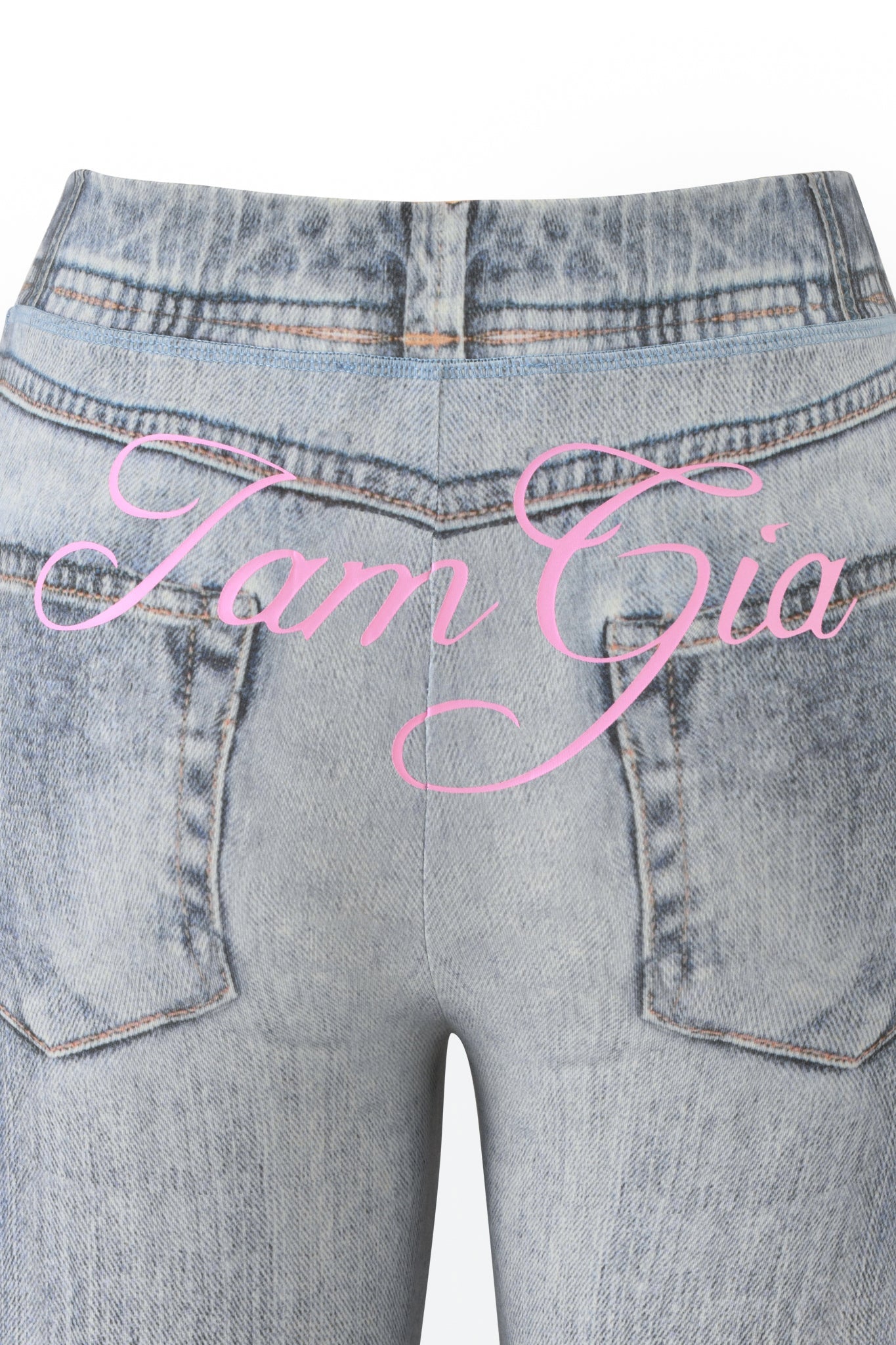 Close-up of the BLARE TRACKPANT - DENIM TROMPE L'OEIL by I.AM.GIA, featuring a faux-denim finish and bold pink “I.AM.GIA” lettering across the back pockets.