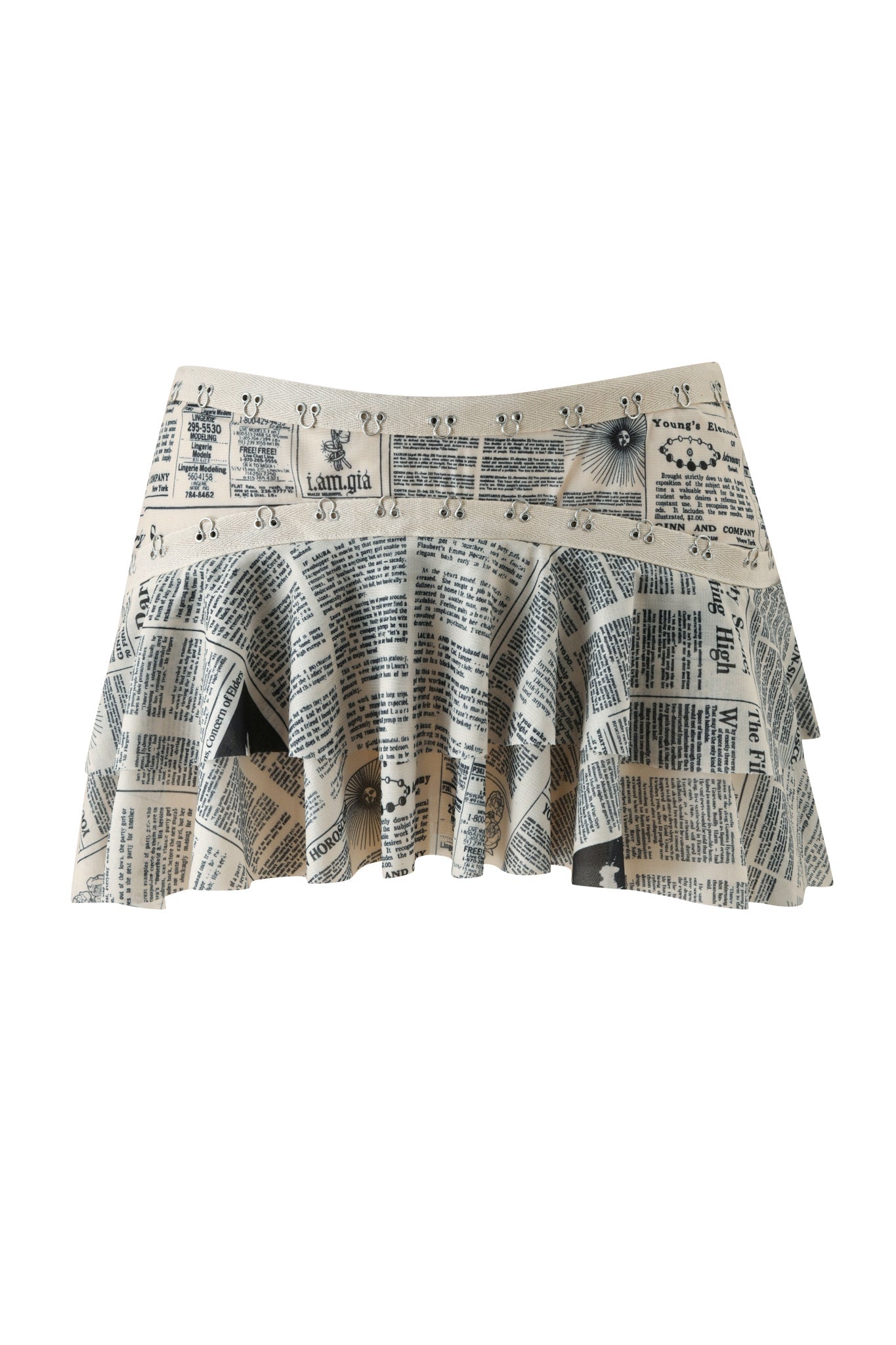 Introducing the SORA MINI SKIRT - LEFT ON READ by I.AM.GIA: a low-rise mesh ruffle mini skirt showcasing a striking black and white newspaper print on lightweight, airy fabric.