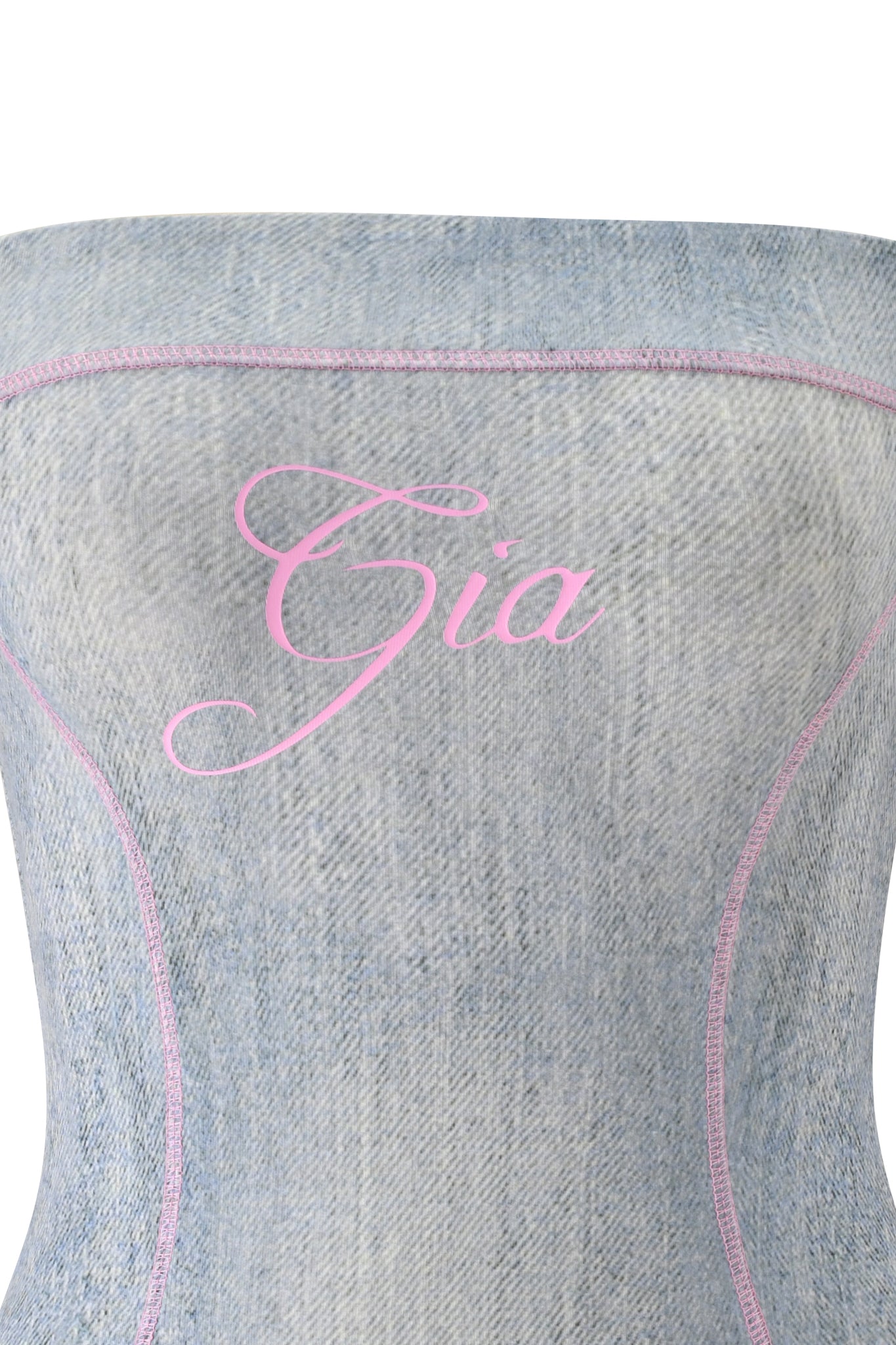 Channel bold I.AM.GIA style in the BLARE TUBE MINI DRESS - DENIM TROMPE L'OEIL, a light blue strapless mini dress featuring pink stitching and "Gia" in pink cursive across the chest—perfect for standout summer looks.
