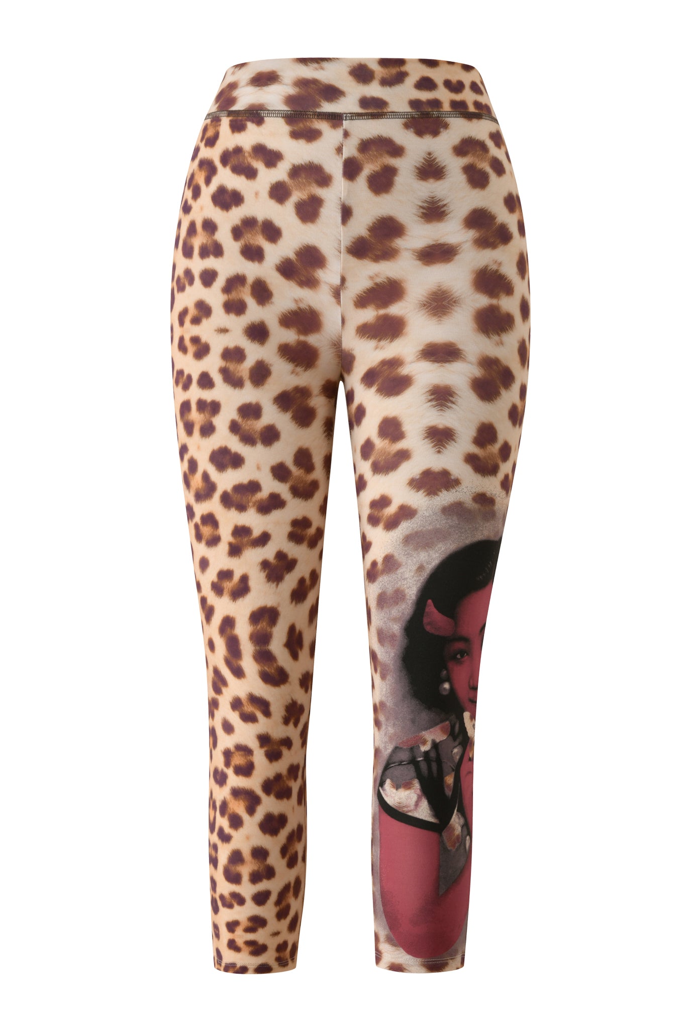 The I.AM.GIA T-REX BLARE CAPRI - WILD CARD leggings combine classic leopard print with a bold artistic portrait of a woman in a headscarf and patterned shirt, featured in red tones on the lower right leg, creating a statement look inspired by the iconic Blare style.