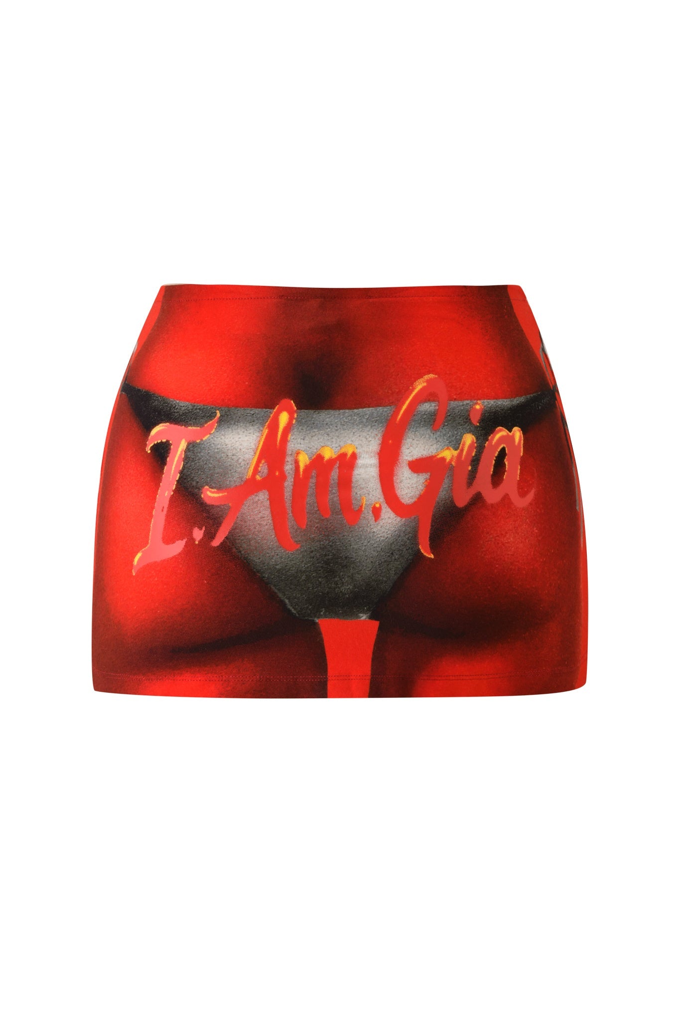 The T-REX BLARE MINI SKIRT by I.AM.GIA is a red mini skirt showcasing gold "I.AM.GIA" lettering and an airbrush bikini print that features a black thong design on a bold red background.