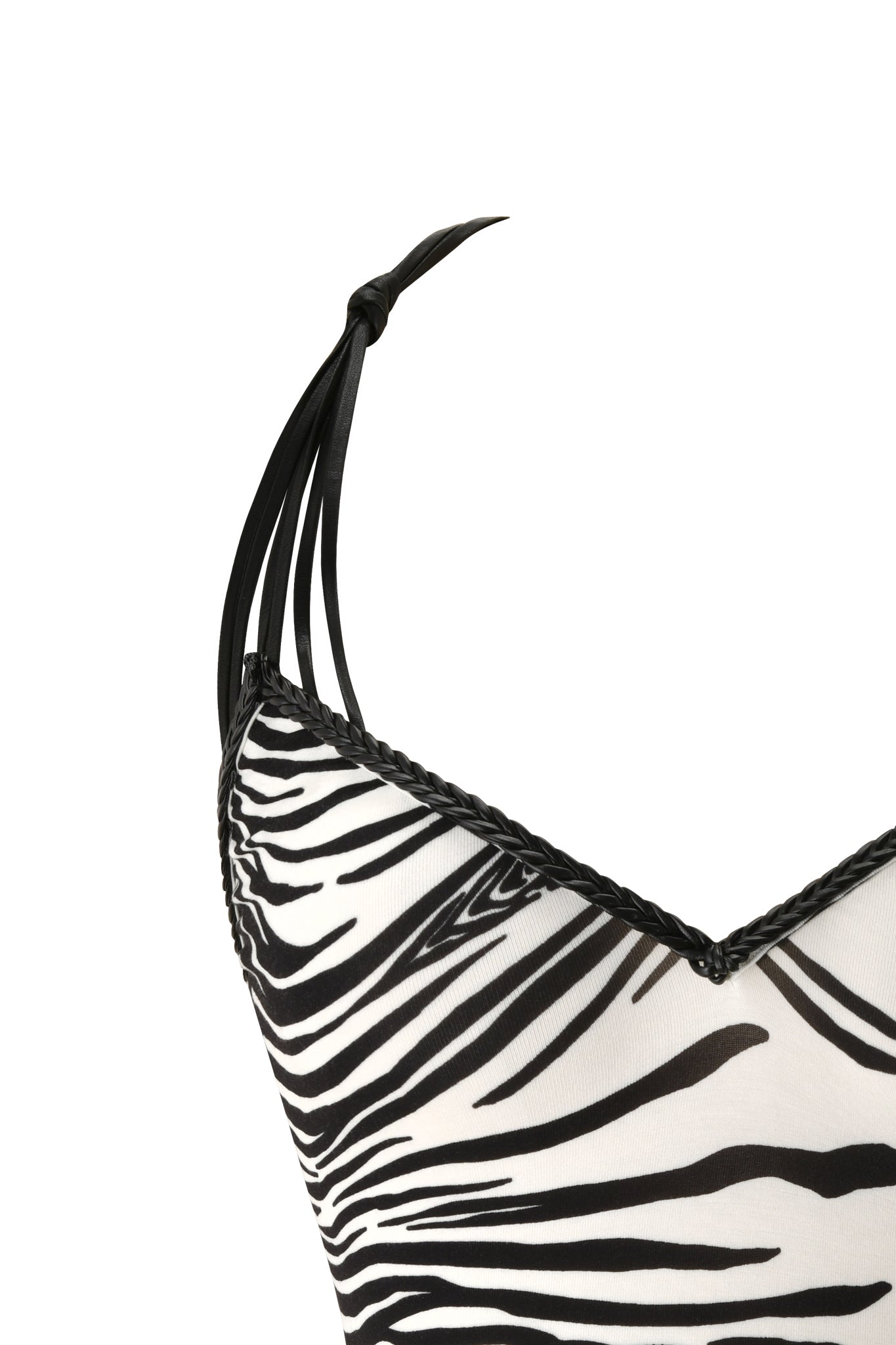 Close-up of the SYD TOP - FINE LINE ZEBRA by I.AM.GIA, featuring bold black and white zebra stripes, thin black shoulder straps, and braided trim along the neckline—a standout piece for your next festival look.