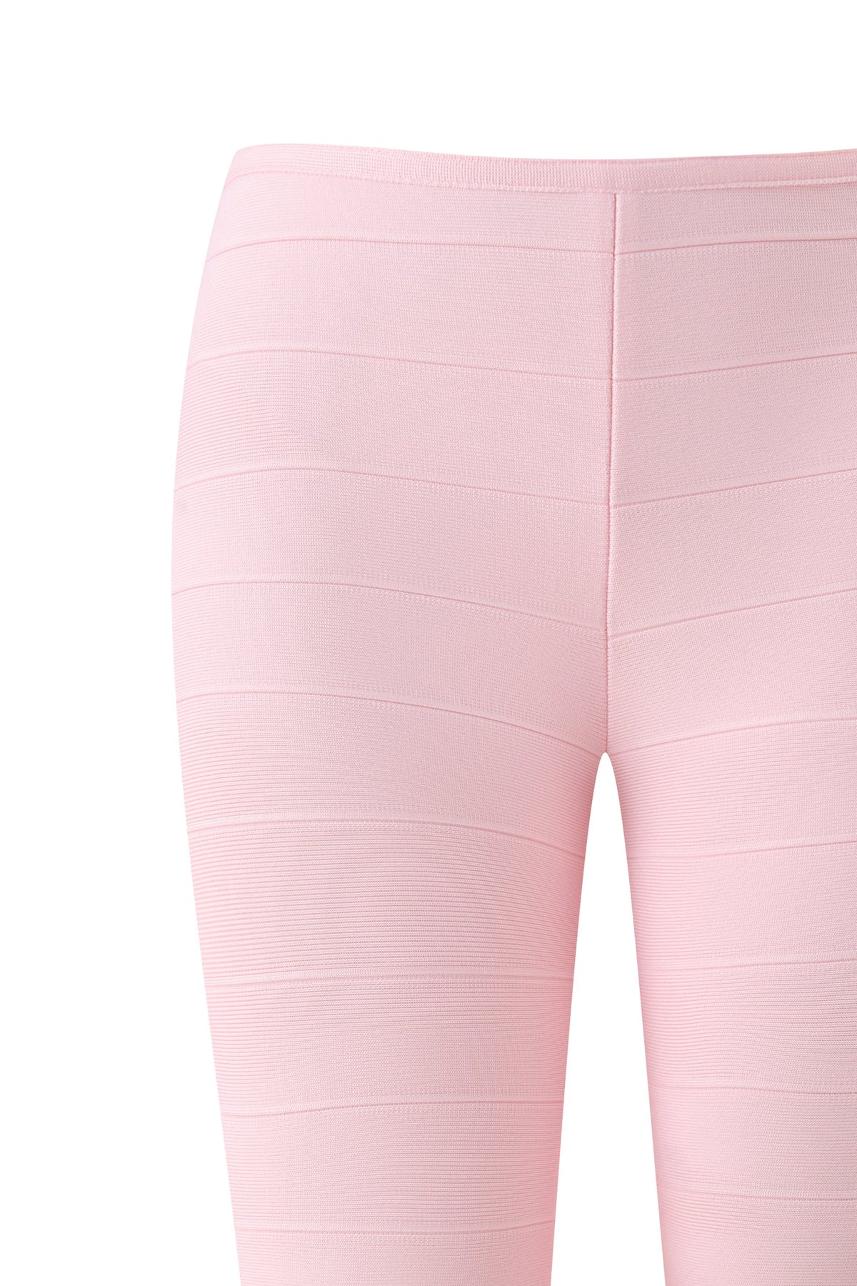 Close-up of the MAEVE BANDAGE CAPRI in Baby Pink by I.AM.GIA, featuring ribbed, horizontal textured lines and highlighting the waist and upper leg area against a white background.