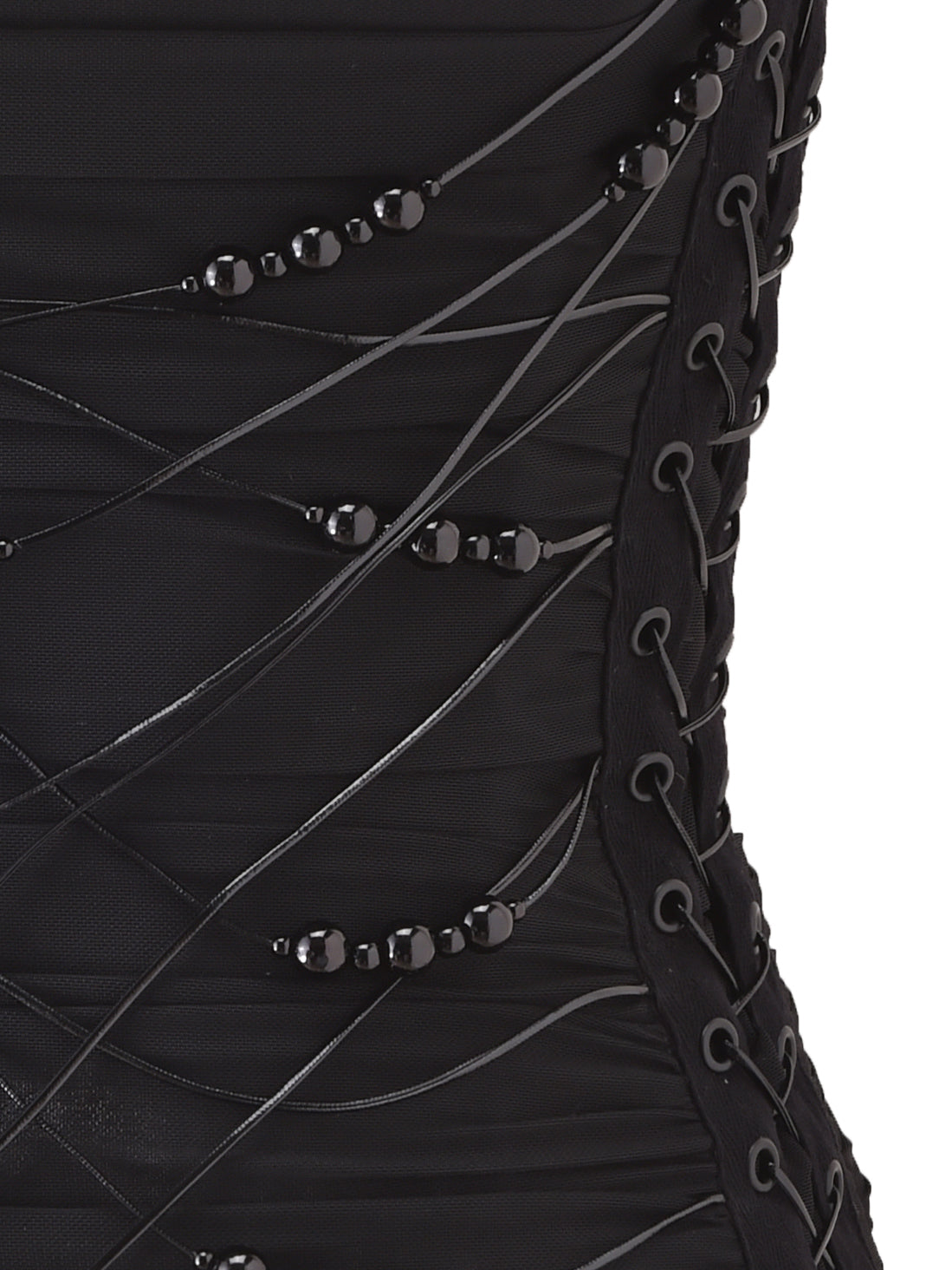Close-up of the DIXI CORSET - BLACK by I.AM.GIA, featuring decorative black beads and crisscrossing laces threaded through eyelets for a textured, elegant pattern.