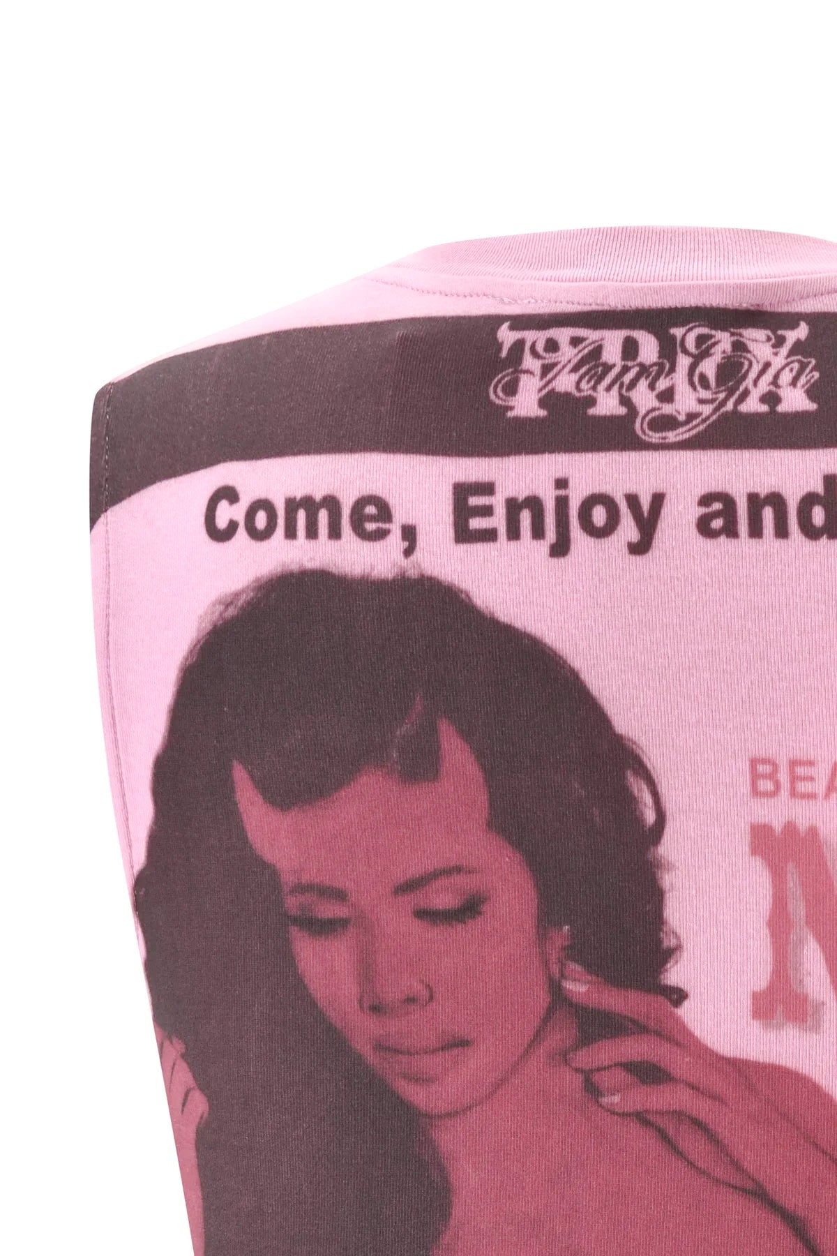 Introducing the T-REX COURTNEY TANK - PINK by I.AM.GIA: a baby pink muscle tank crafted from heavyweight cotton jersey, featuring an exclusive, vintage-inspired placement print of a dark-haired woman with the text "Come, Enjoy and" above her head for a bold and standout look.