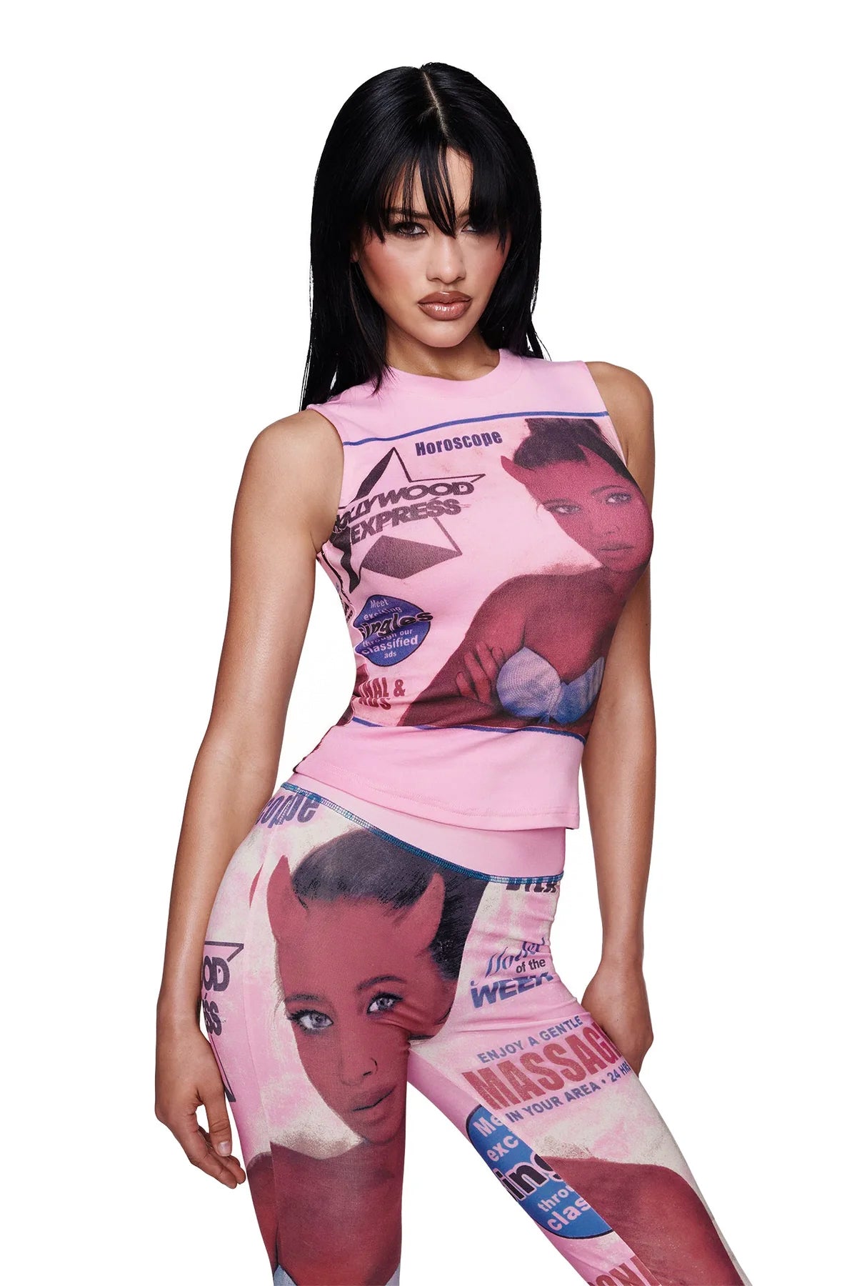A woman with long black hair wears the I.AM.GIA T-REX COURTNEY TANK in pink, paired with matching leggings that feature exclusive placement prints of retro magazine graphics and illustrations of a woman's face. She poses confidently against a white background.