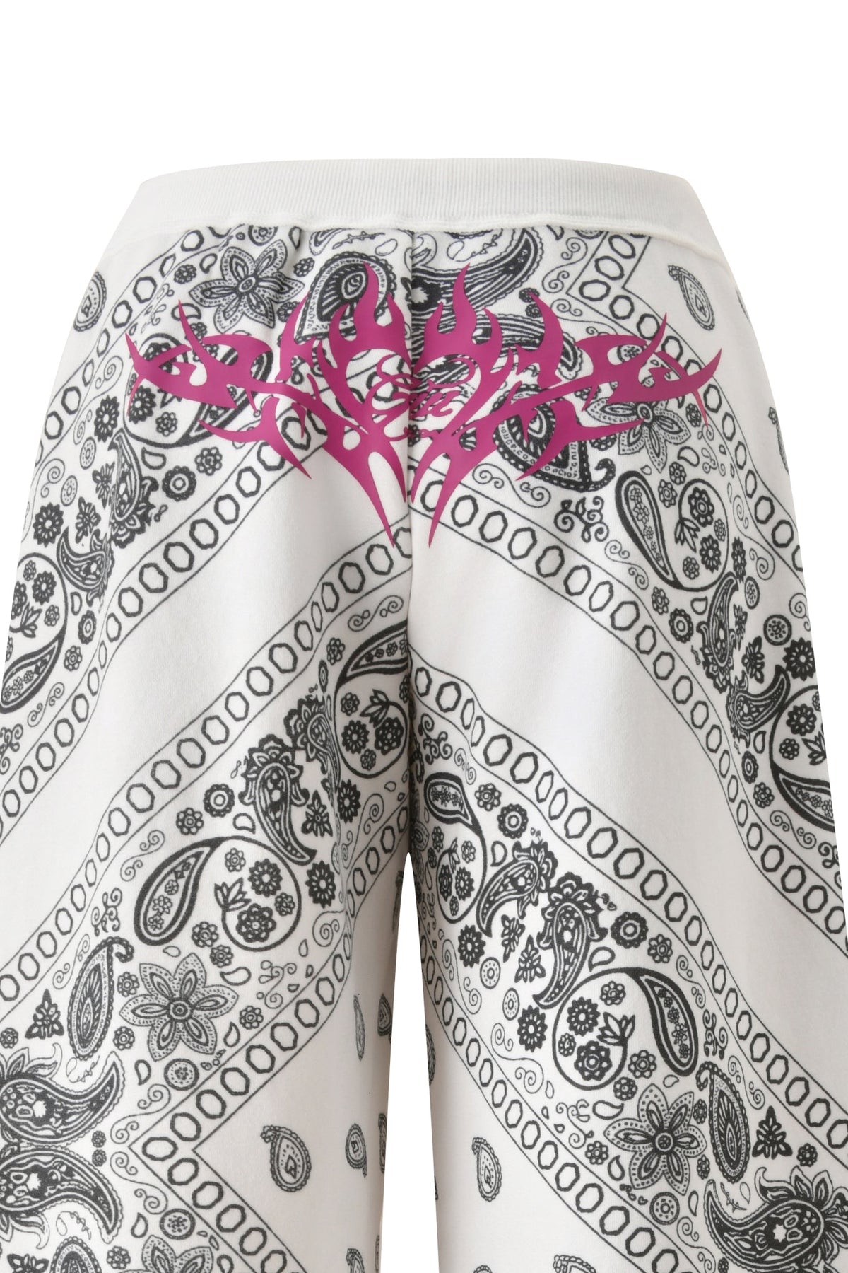 The T-REX TRACKPANT - PAISLEY by I.AM.GIA features white wide legs with black paisley and bandana patterns, plus a bold pink tribal design across the back waistband.