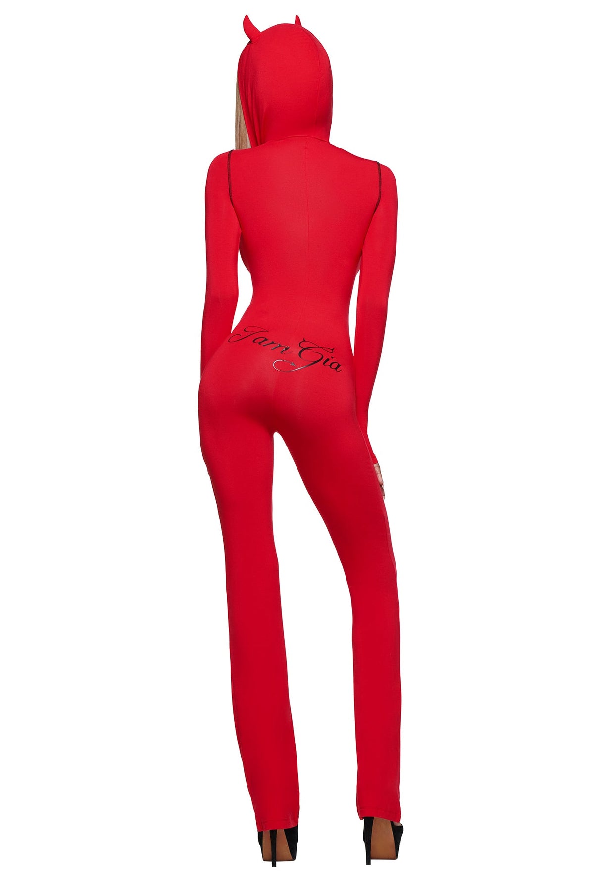 A person in the BLARE HORN JUMPSUIT - RED by I.AM.GIA, featuring a devil horn hood and “I.AM.GIA” printed across the back, stands facing away from the camera.