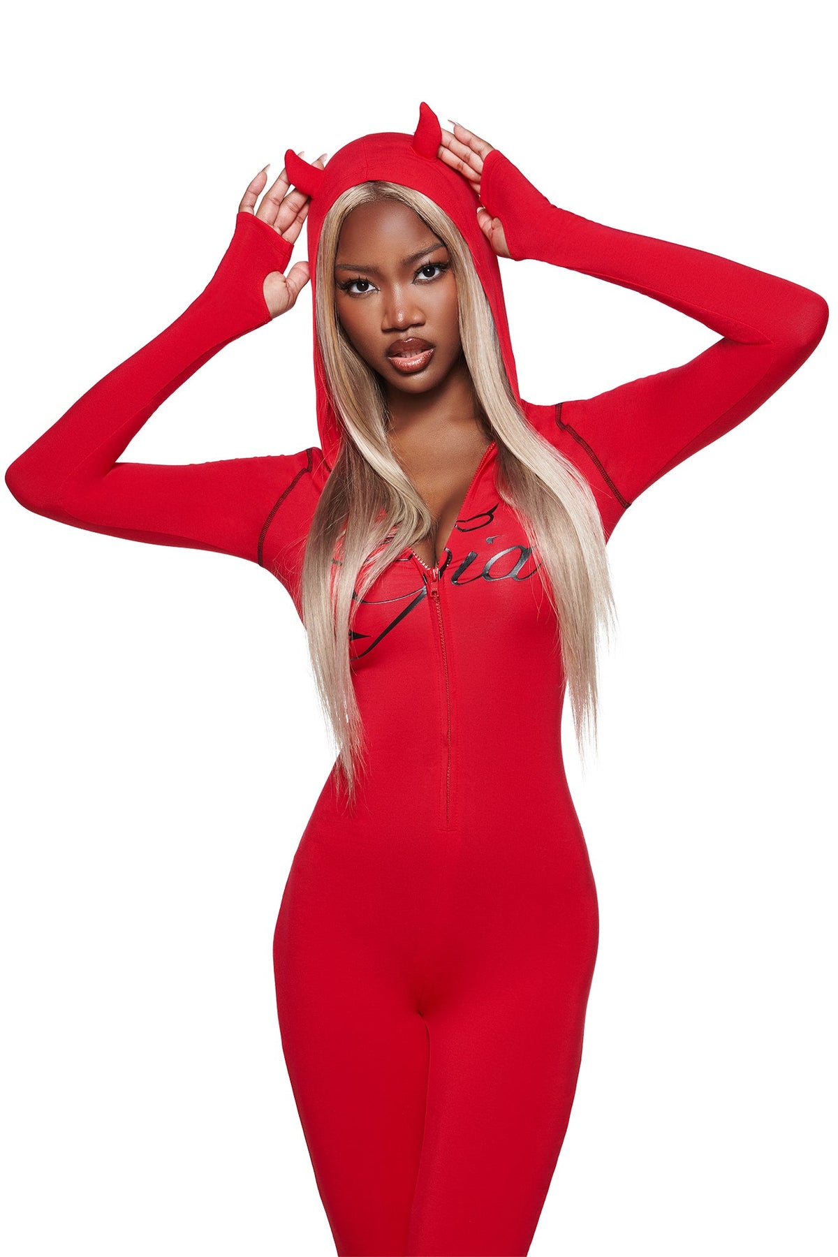 Woman in a fitted BLARE HORN JUMPSUIT - RED by I.AM.GIA, posing against a white background as she adjusts the playful devil horn hood.