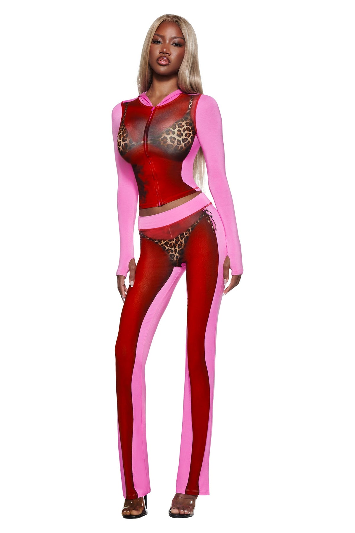 Model wearing the I.AM.GIA T-REX SPRAY BODY BLARE TRACKPANT - PINK with airbrushed bikini body print and leopard details, paired with high heels against a white background.