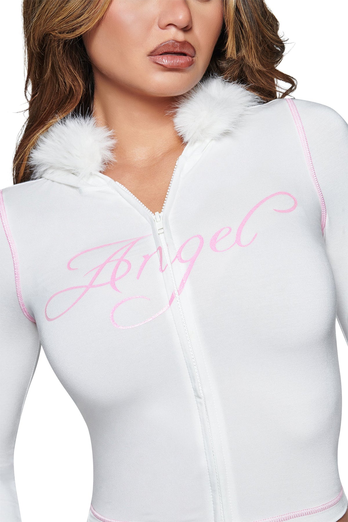 A person wearing the I.AM.GIA BLARE FUR TRIM HOODIE in white, featuring fluffy white trim at the collar and “Angel” written in pink script across the chest.