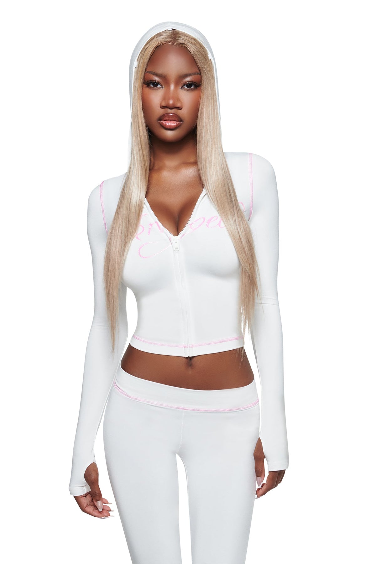 A woman with long straight blonde hair wears the I.AM.GIA BLARE FUR TRIM HOODIE in white, styled with matching white pants, standing against a plain white background.