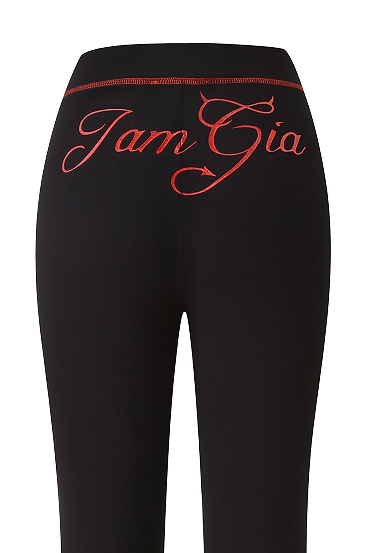 Introducing the BLARE TRACKPANT - JET BLACK : DEVIL by I.AM.GIA—sleek black leggings featuring the striking black devil GIA logo in large, red, cursive embroidery across the back waistband. Made from soft bamboo fabric, these trackpant leggings deliver both comfort and standout style.