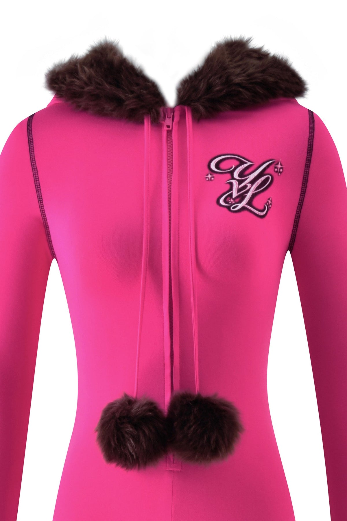 Bright pink long-sleeved YVL BLARE FUR LINED JUMPSUIT - PINK with a brown faux fur-trimmed hood, brown pom-poms on the zipper pull, and a decorative “YL” emblem on the chest.