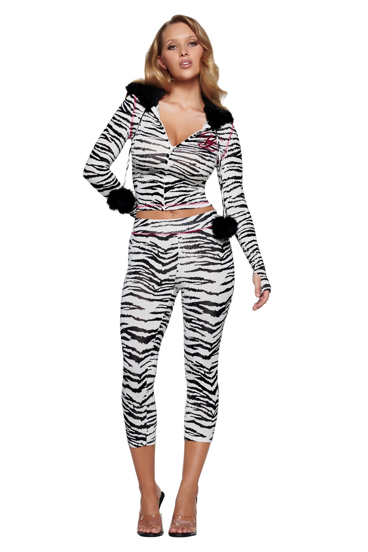 Woman wearing a zebra-print YVL BLARE FUR LINED HOODIE - ZEBRA with black faux-fur trim and matching cropped leggings.