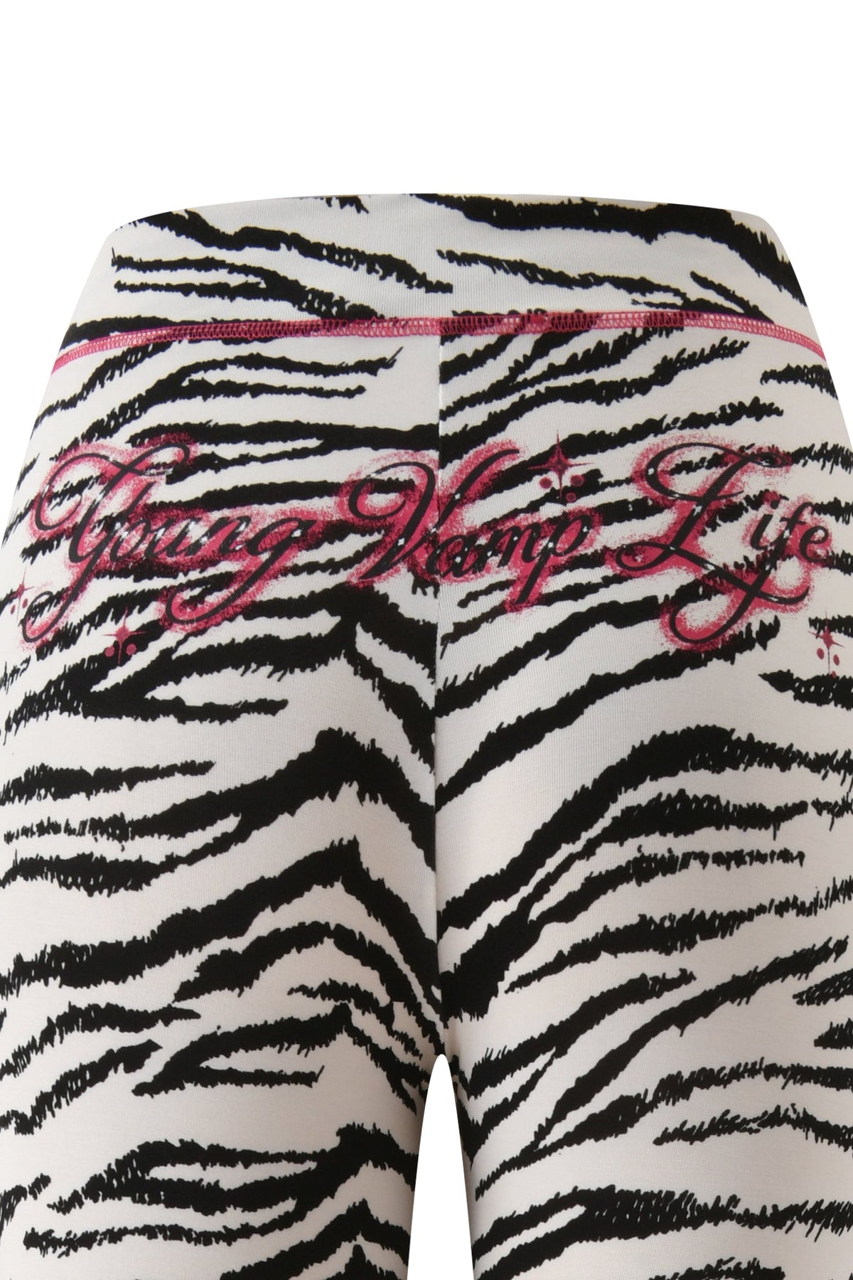 Close-up of I.AM.GIA YVL BLARE TRACKPANT - ZEBRA with flared legs, featuring “Young Vamp Life” embroidered in pink script across the back.