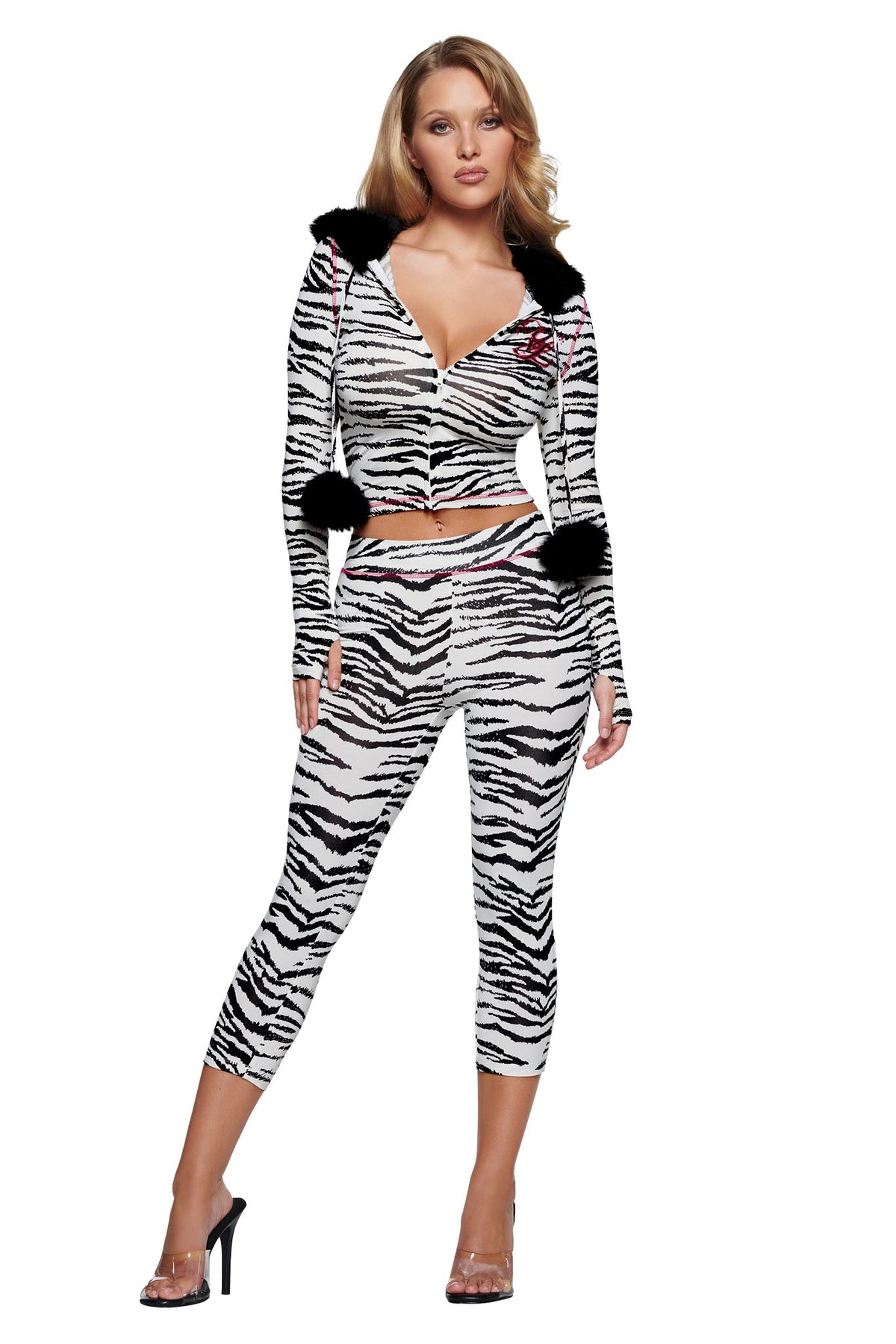 A woman wears a zebra-print hooded zip-up crop top with black pom-poms and matching YVL BLARE CAPRI - ZEBRA pants.