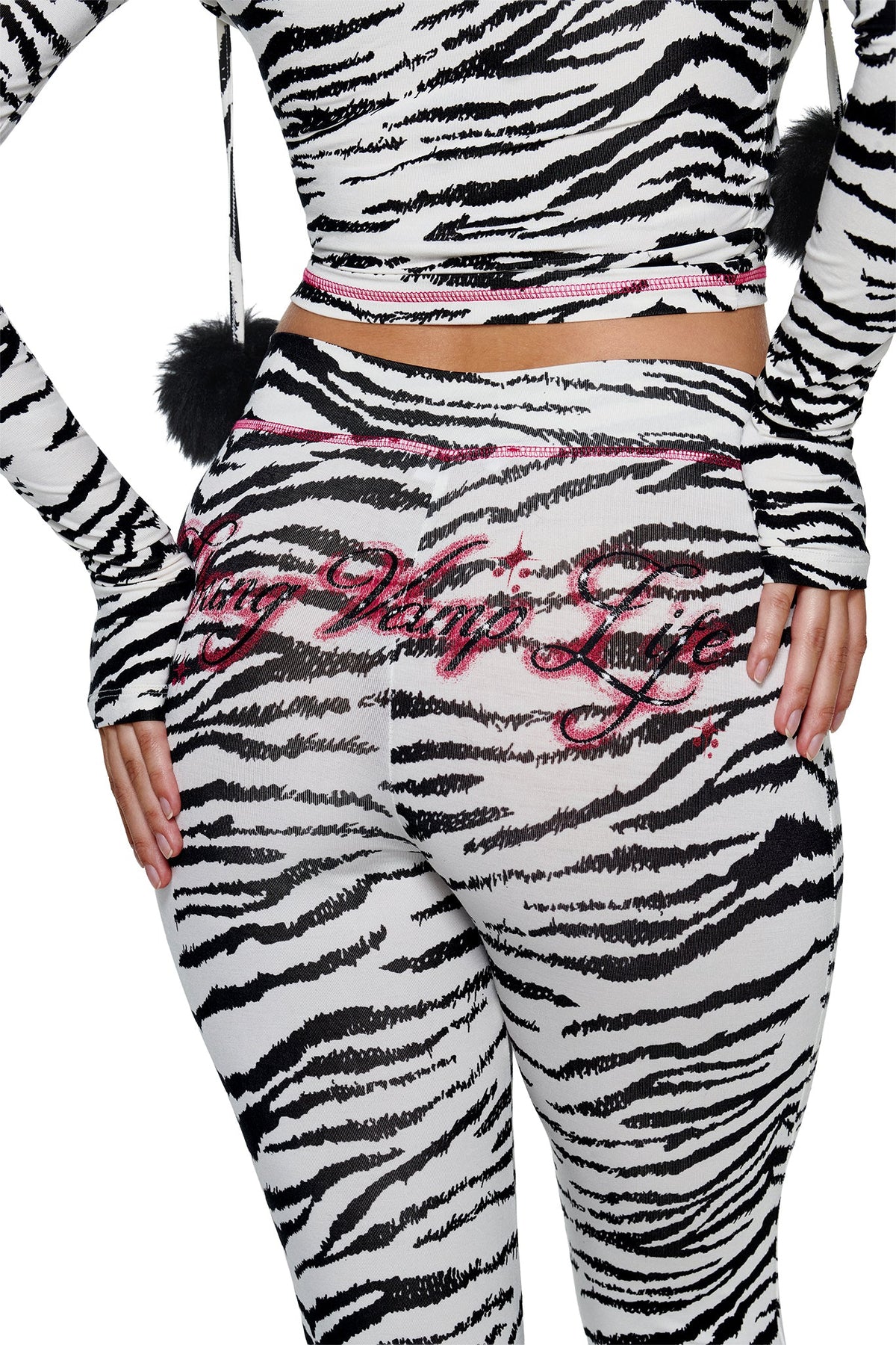 YVL BLARE CAPRI - ZEBRA leggings in a zebra print with pink stitched script text across the back.