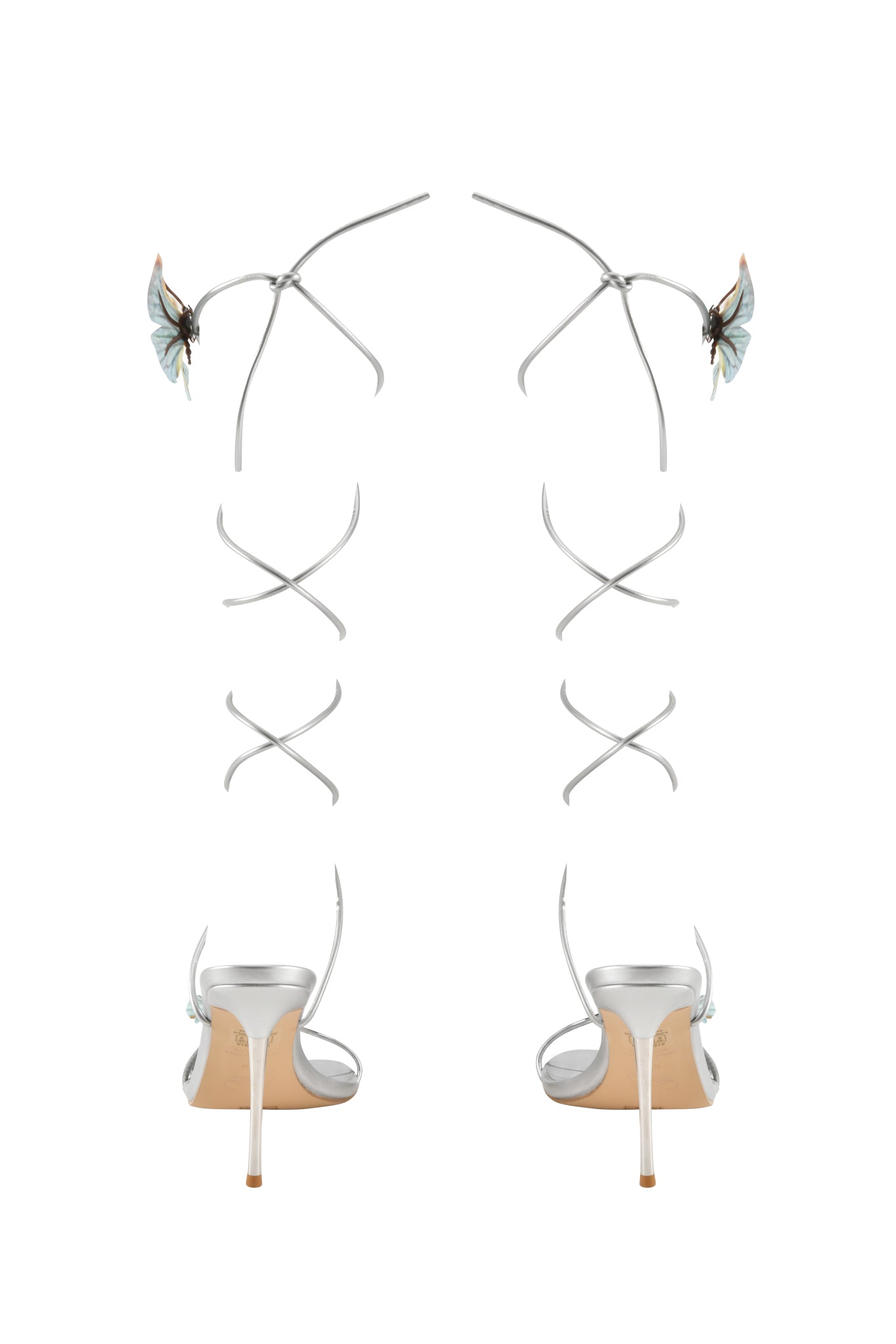 The I.AM.GIA SCARLETTE HEEL - SILVER features metallic strappy open-toe stilettos with long ankle straps, each topped with a blue butterfly applique for a striking, elegant look.