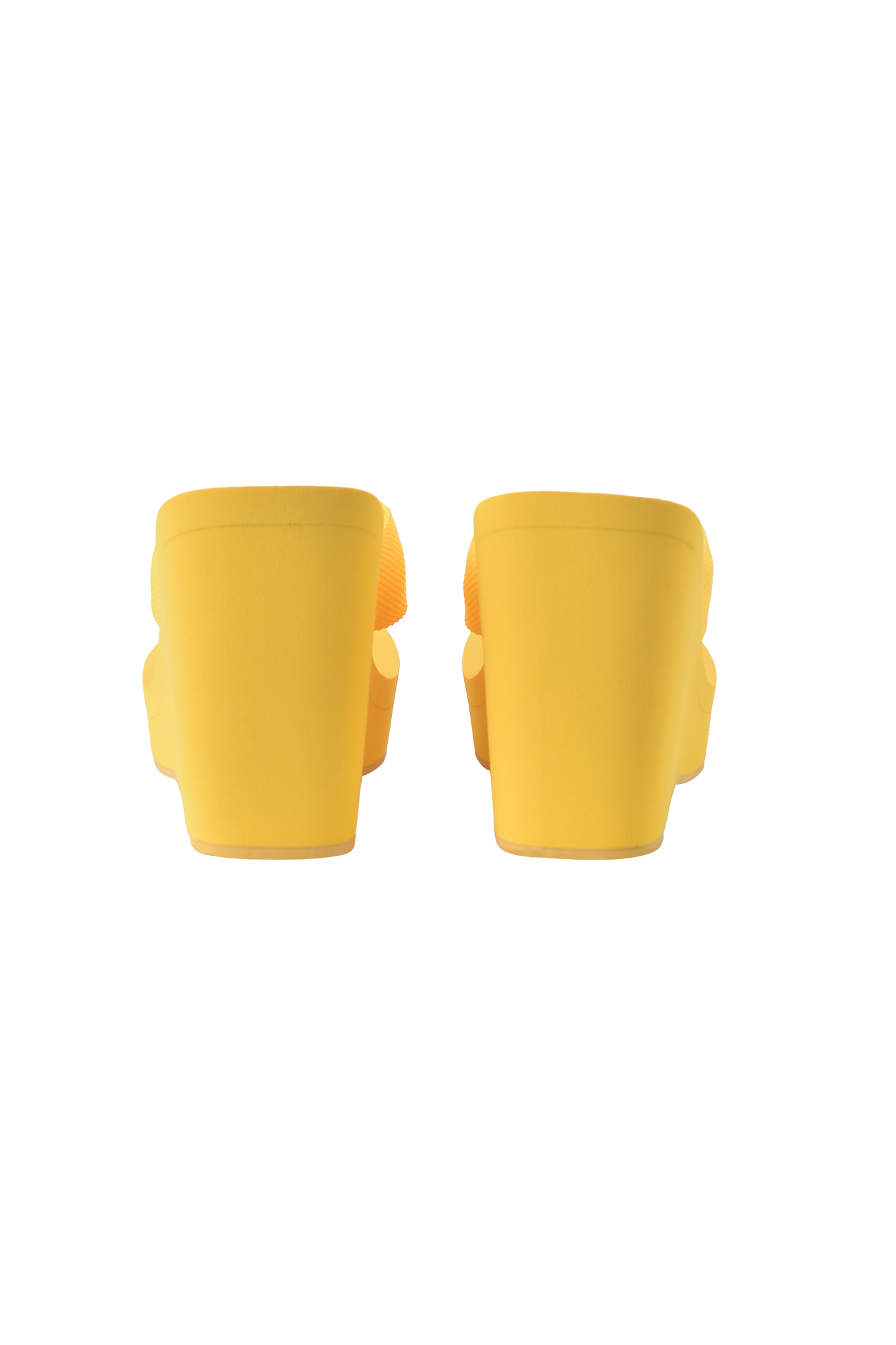 The I.AM.GIA SHELBY FLIP FLOP in bright yellow is shown from the back against a matching yellow background, capturing the brand’s bold style.