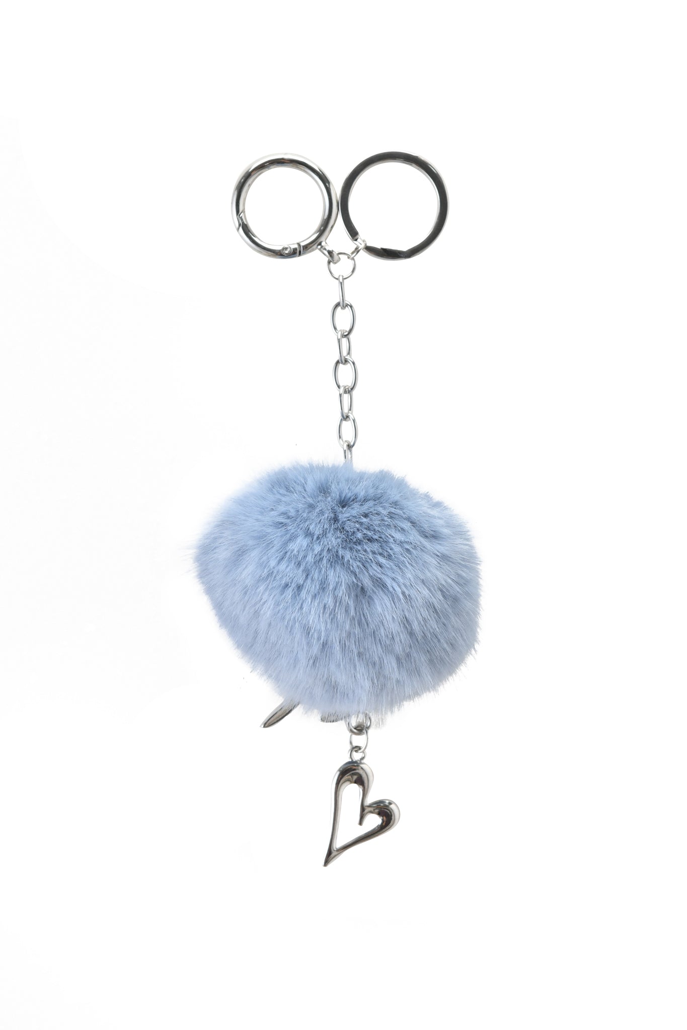The LARSA KEYCHAIN - BLUE by I.AM.GIA features a silver chain, fluffy light blue pom-pom, and dangling heart charm. Add playful elegance to your accessories—custom GIA logo available for personalization.