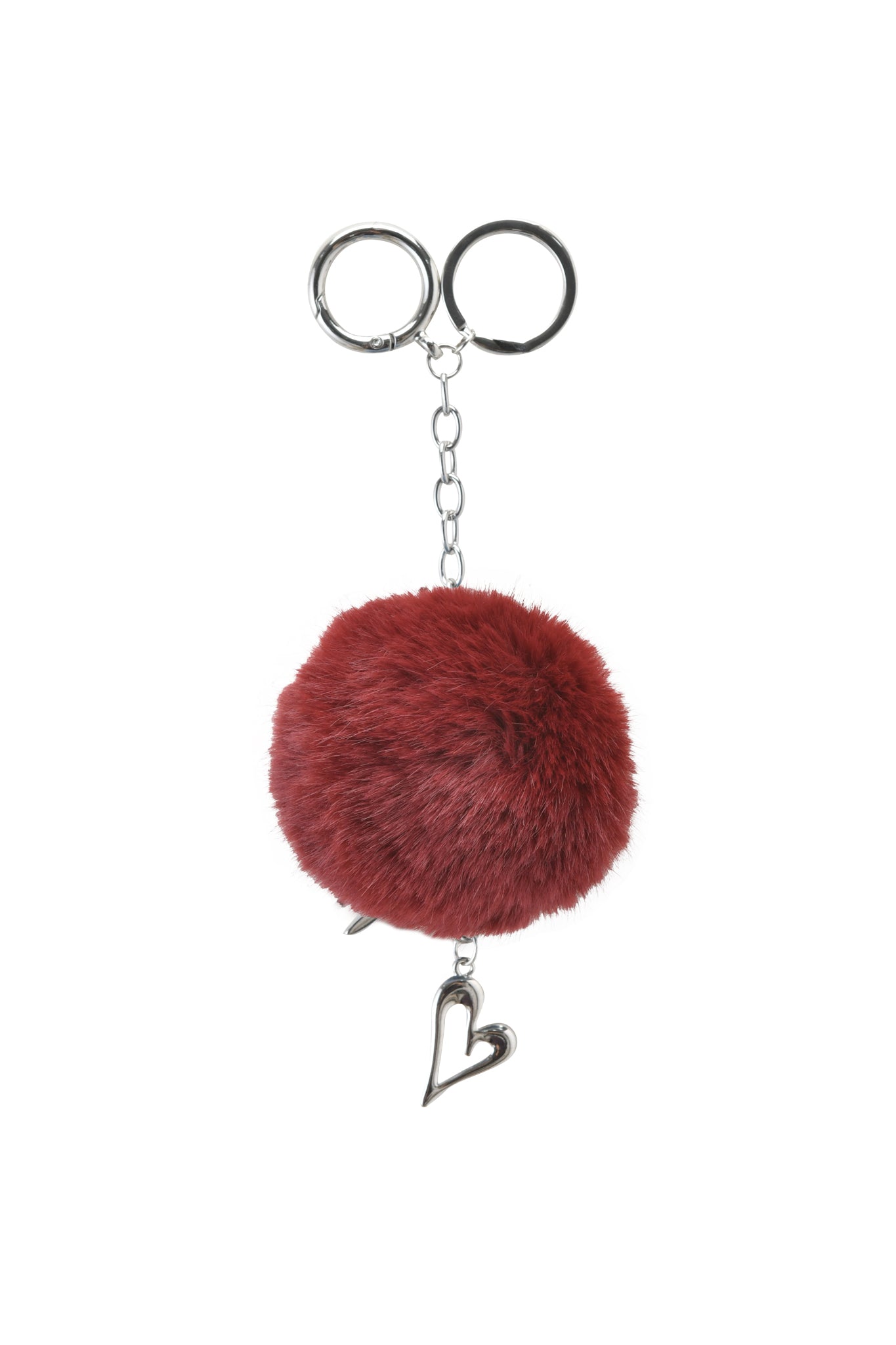 The LARSA KEYCHAIN - RED by I.AM.GIA features a deep red fluffy pom-pom, silver chain, two key rings, and a silver heart charm with GIA logo hardware, displayed against a white background.