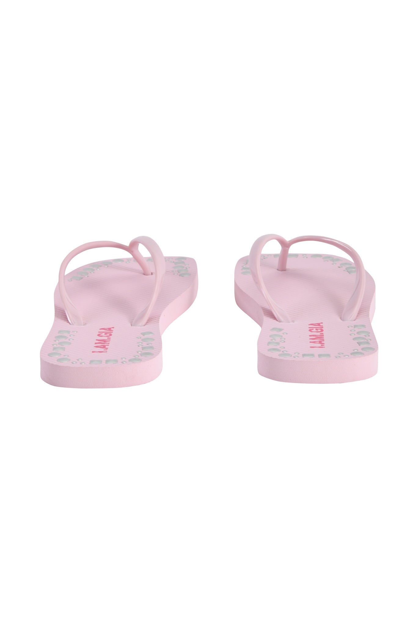 The INKA STUDDED FLIP FLOP - BABY PINK by I.AM.GIA is shown from the back, highlighting the heel sides and soles with light green and red text.