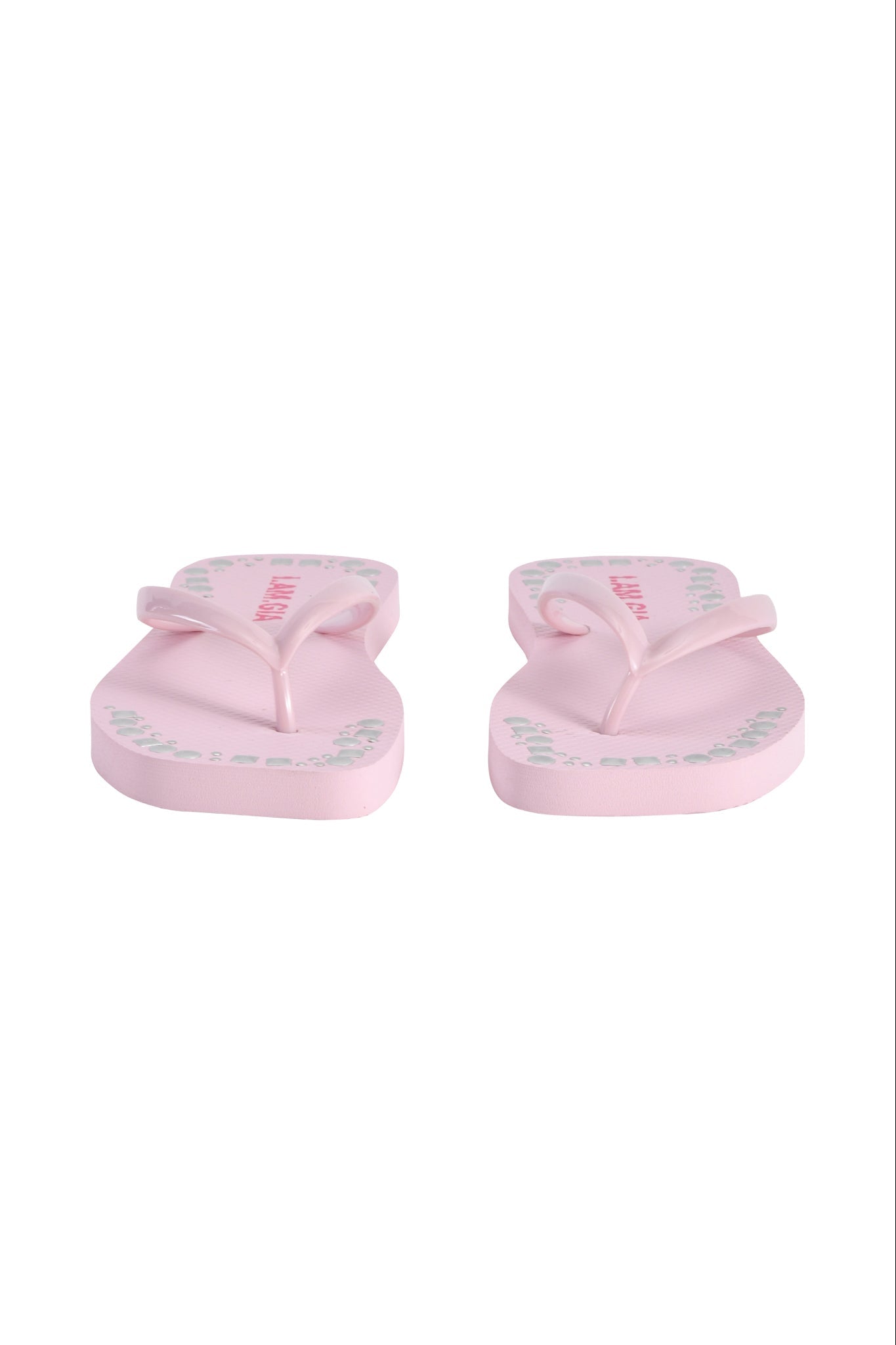 The INKA STUDDED FLIP FLOP - BABY PINK by I.AM.GIA is shown from the front against a white background, with light green and pink text and patterns on the footbeds.