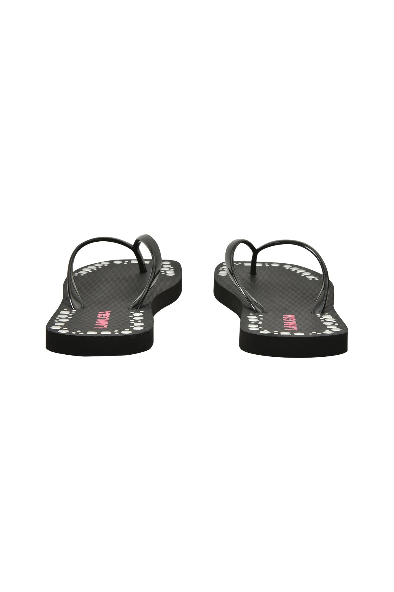 The I.AM.GIA INKA STUDDED FLIP FLOP in black features thin straps, an extra-soft foam footbed, and white dot detailing along the sole edges, shown here from the back.