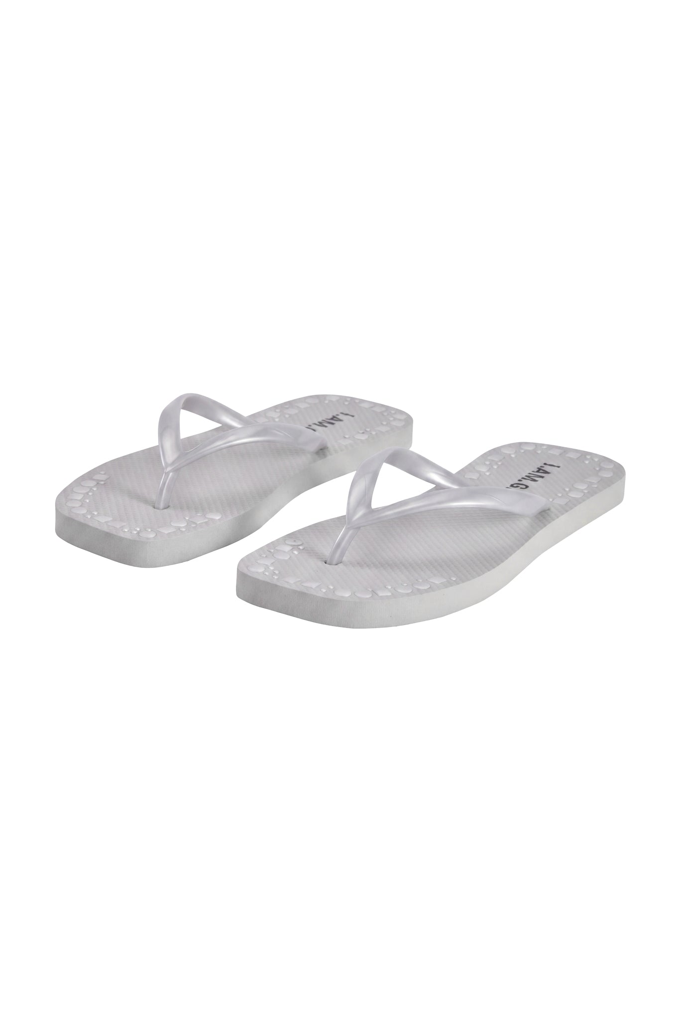 The INKA STUDDED FLIP FLOP - SILVER by I.AM.GIA features comfortable footbeds, textured soles, and sleek silver-studded straps, shown side by side on a plain white background.