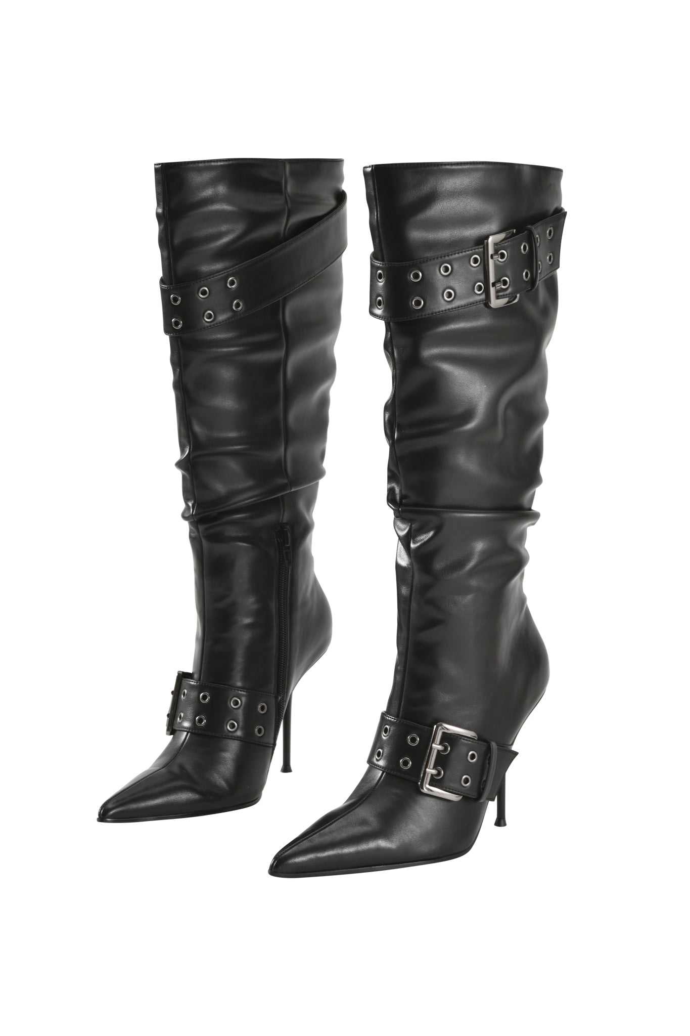 Step out in the I.AM.GIA KINTH BOOT 2.0 – BLACK: a pair of tall, black faux-leather knee-high boots featuring pointed toes, high stiletto heels, and harness buckle straps with metal eyelets decorating the ankle and upper shaft, shown here against a white background.