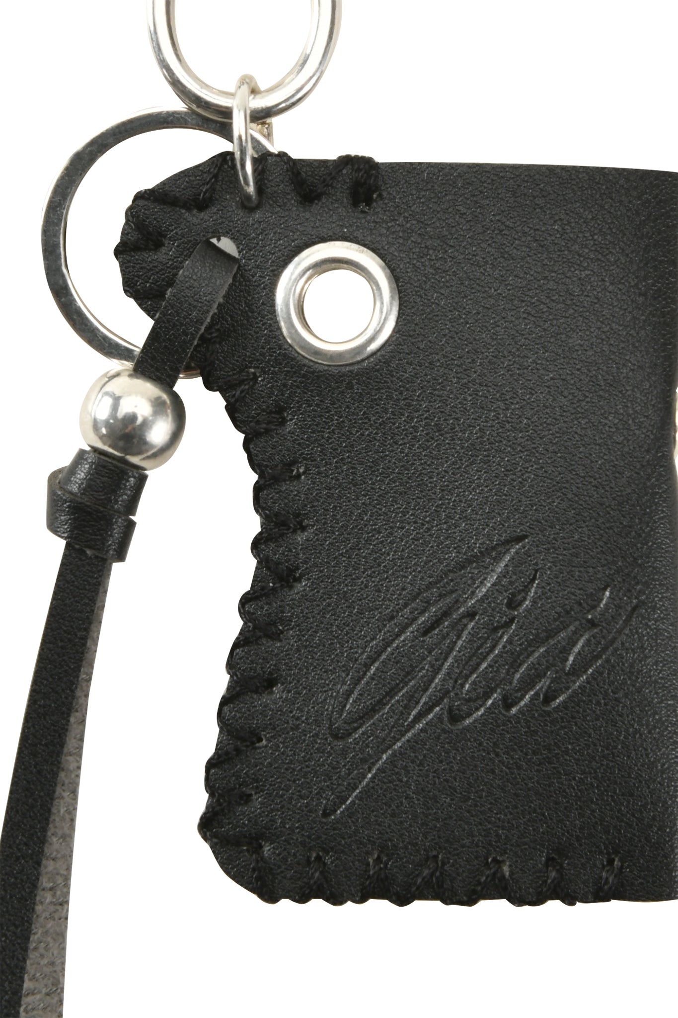 Close-up of the I.AM.GIA VENUS LIGHTER KEYCHAIN - BLACK, featuring black leather with stitched edges, a metal keyring and small ring, engraved GIA logo, and a decorative strap with a metal bead—resembling a sleek lighter holder.